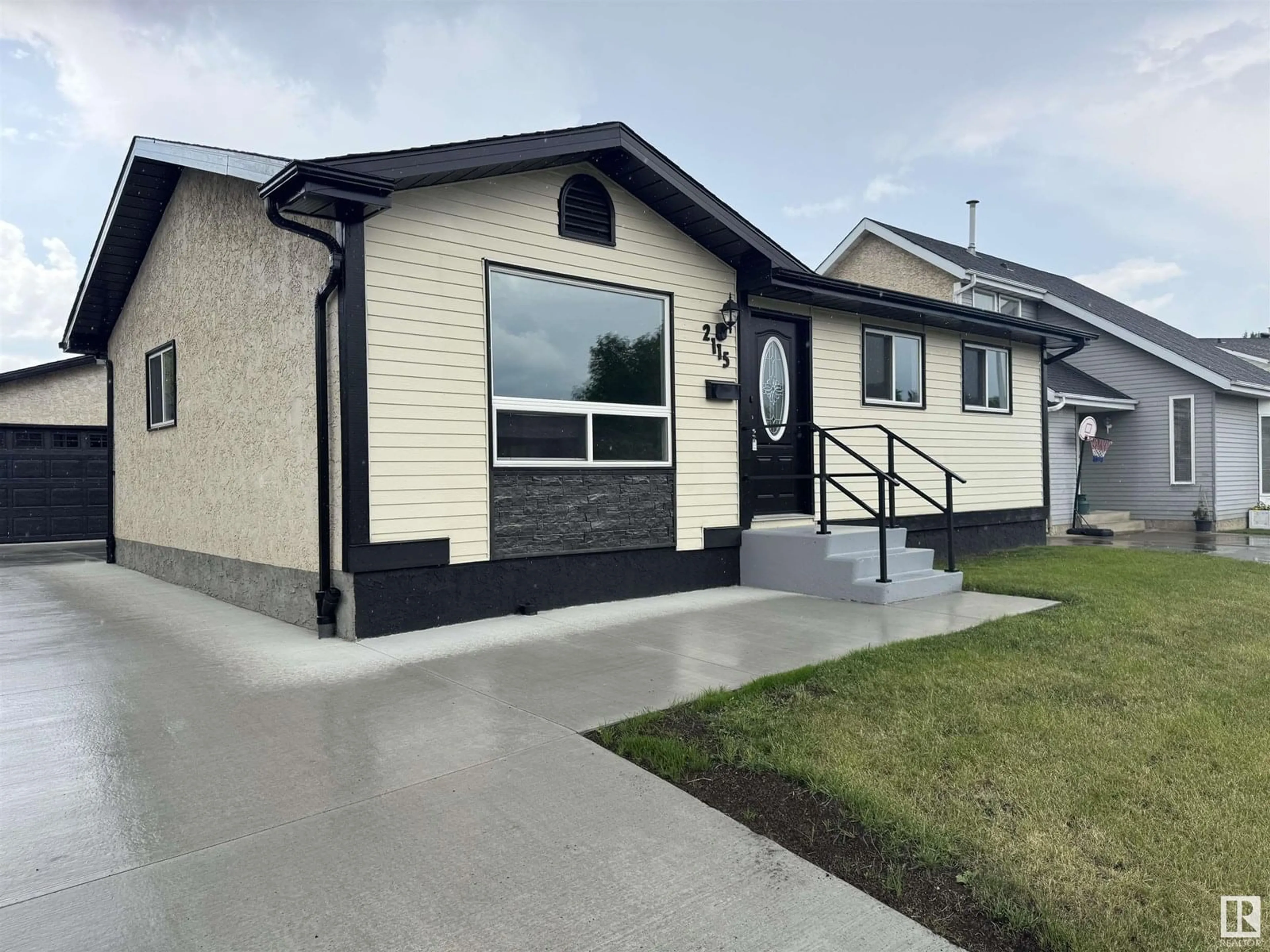 Home with vinyl exterior material, street for 2115 145 AV, Edmonton Alberta T5Y1V1