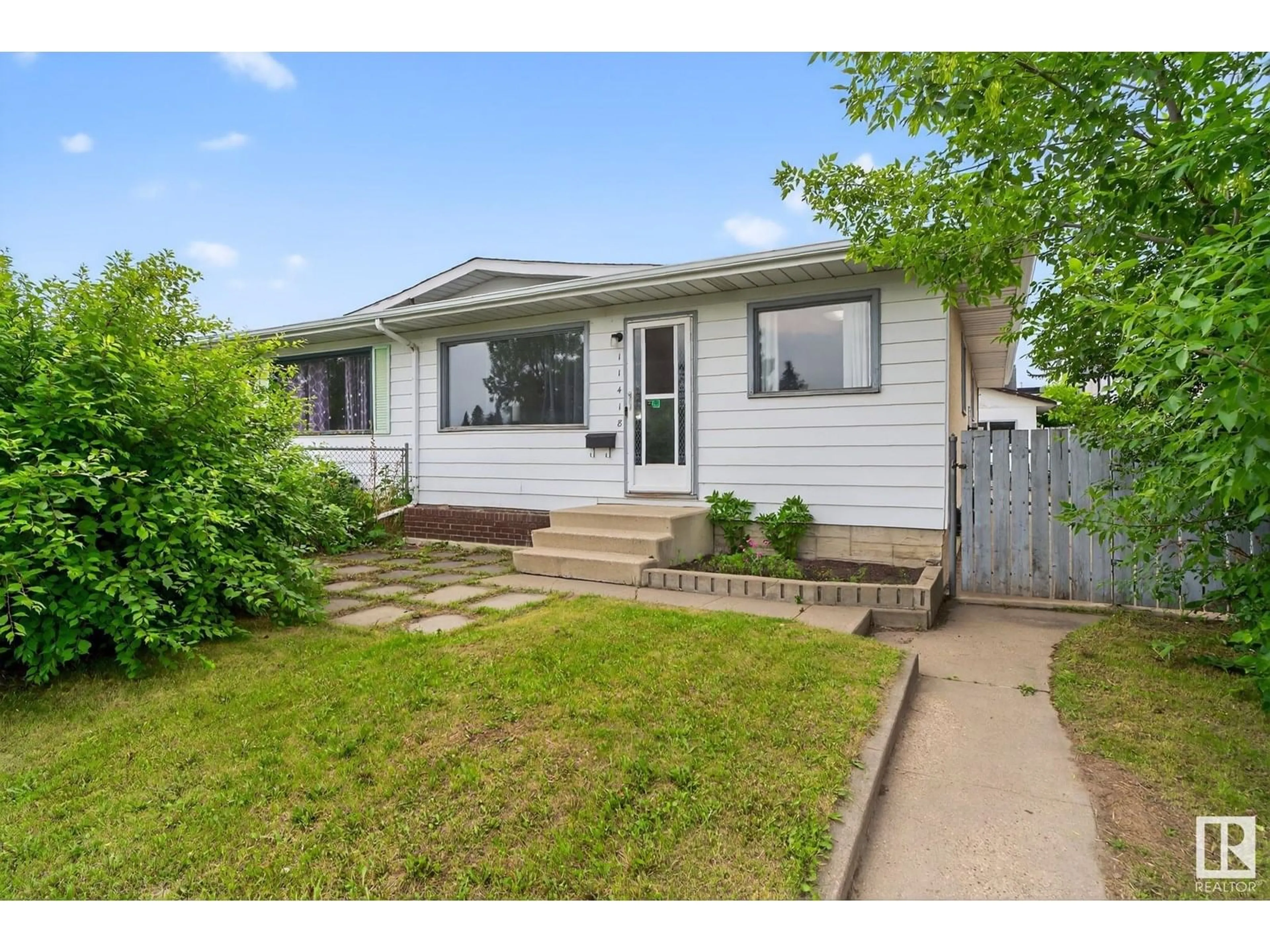 Home with vinyl exterior material, street for 11418 32 ST, Edmonton Alberta T5W4R9