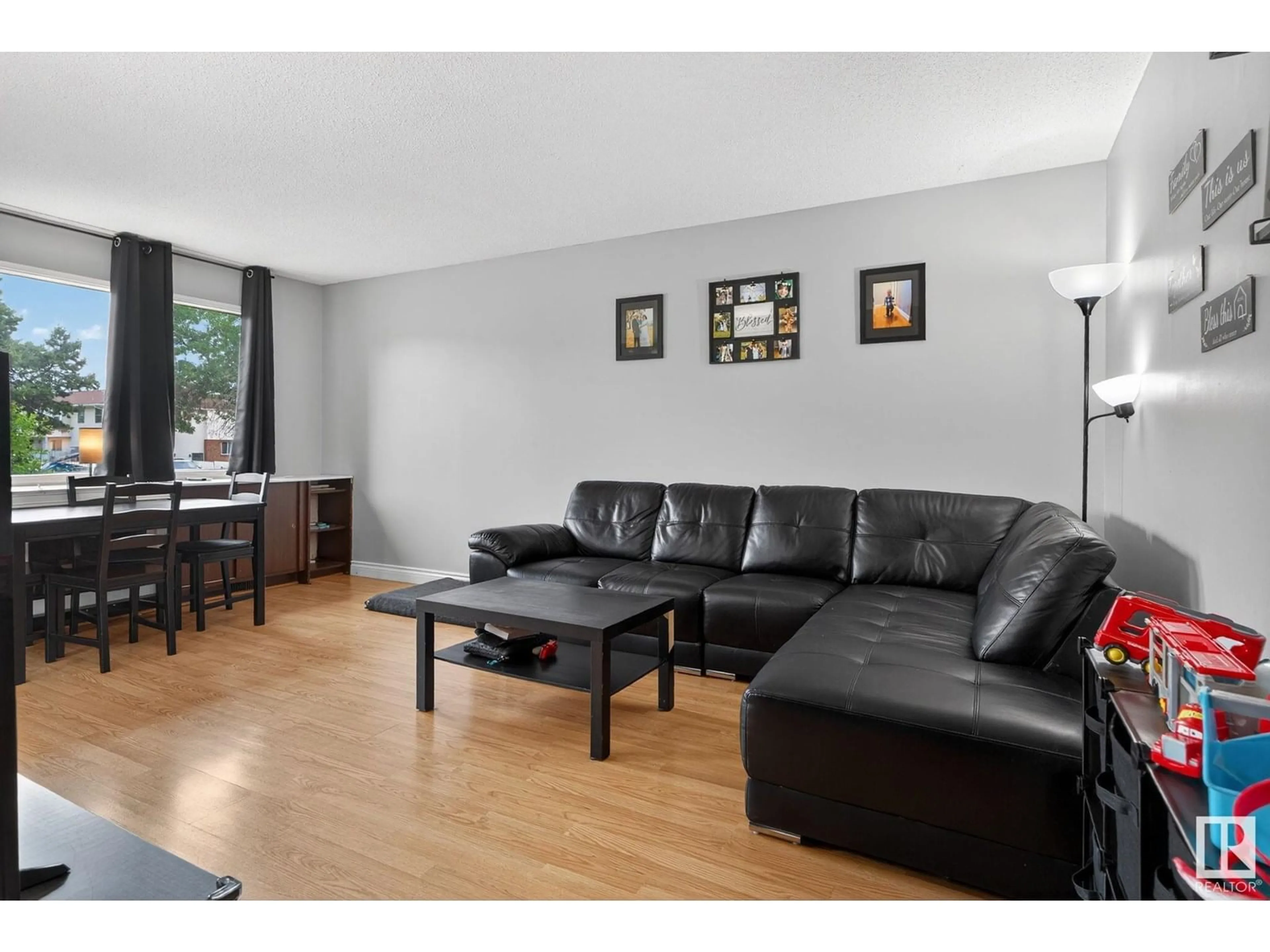 Living room with furniture, wood/laminate floor for 11418 32 ST, Edmonton Alberta T5W4R9