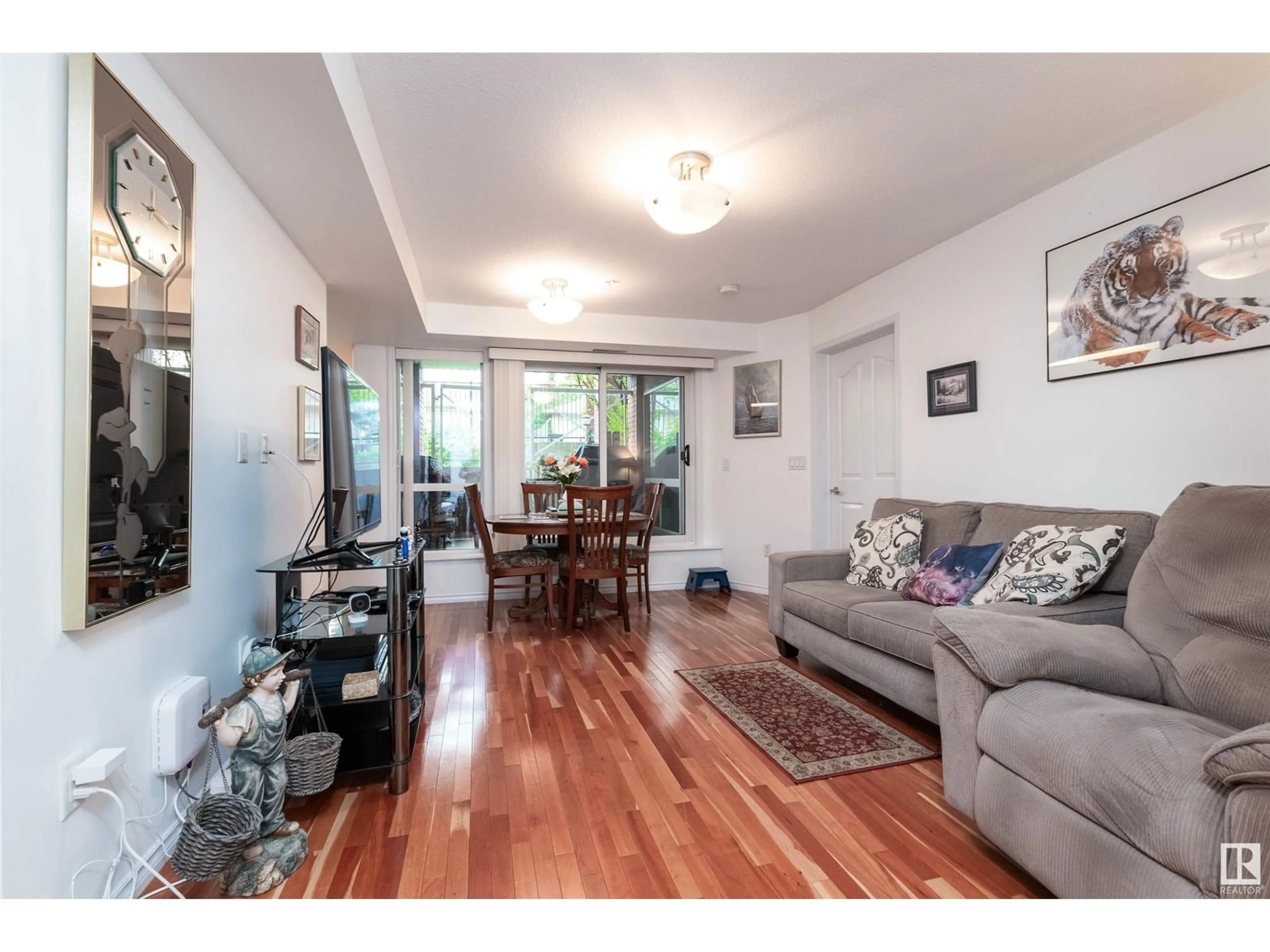 Living room with furniture, wood/laminate floor for #107 - 7510 89 ST, Edmonton Alberta T6C0X5