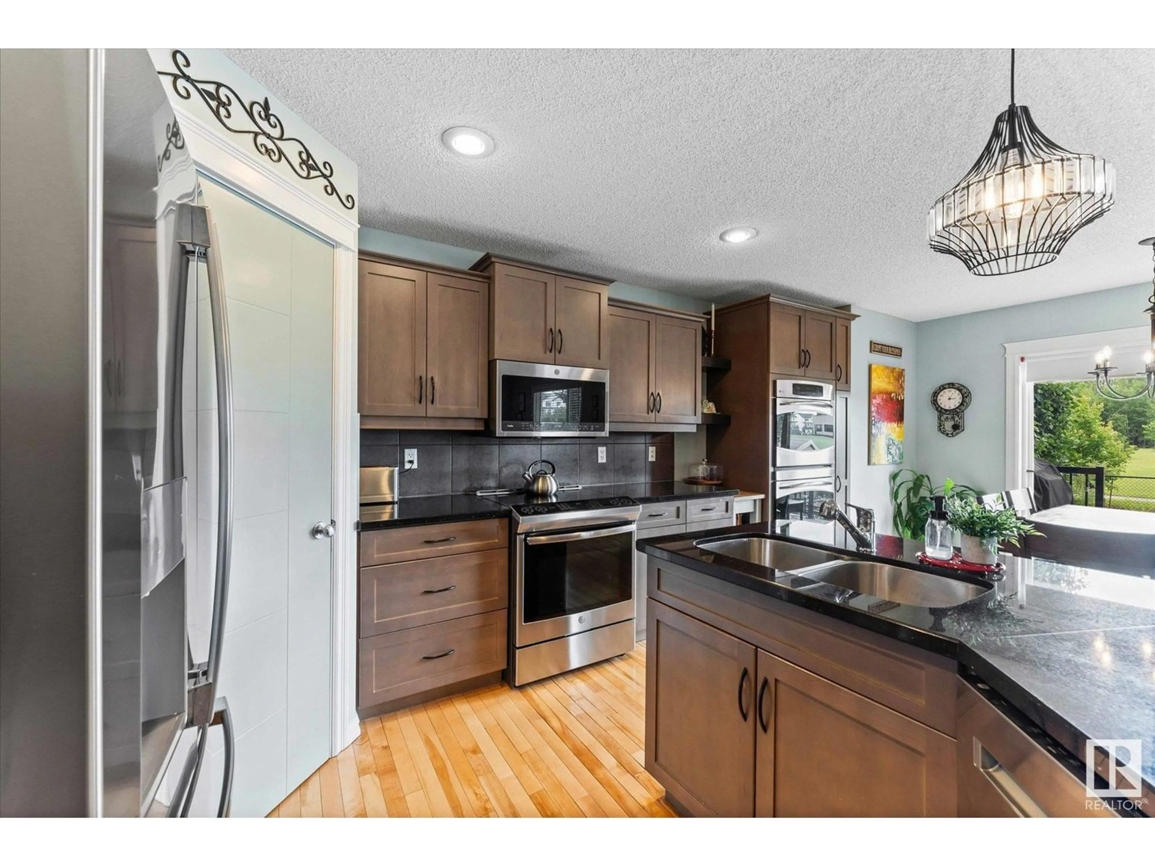 Open concept kitchen, wood/laminate floor for 21921 94A AV, Edmonton Alberta T5T1N1