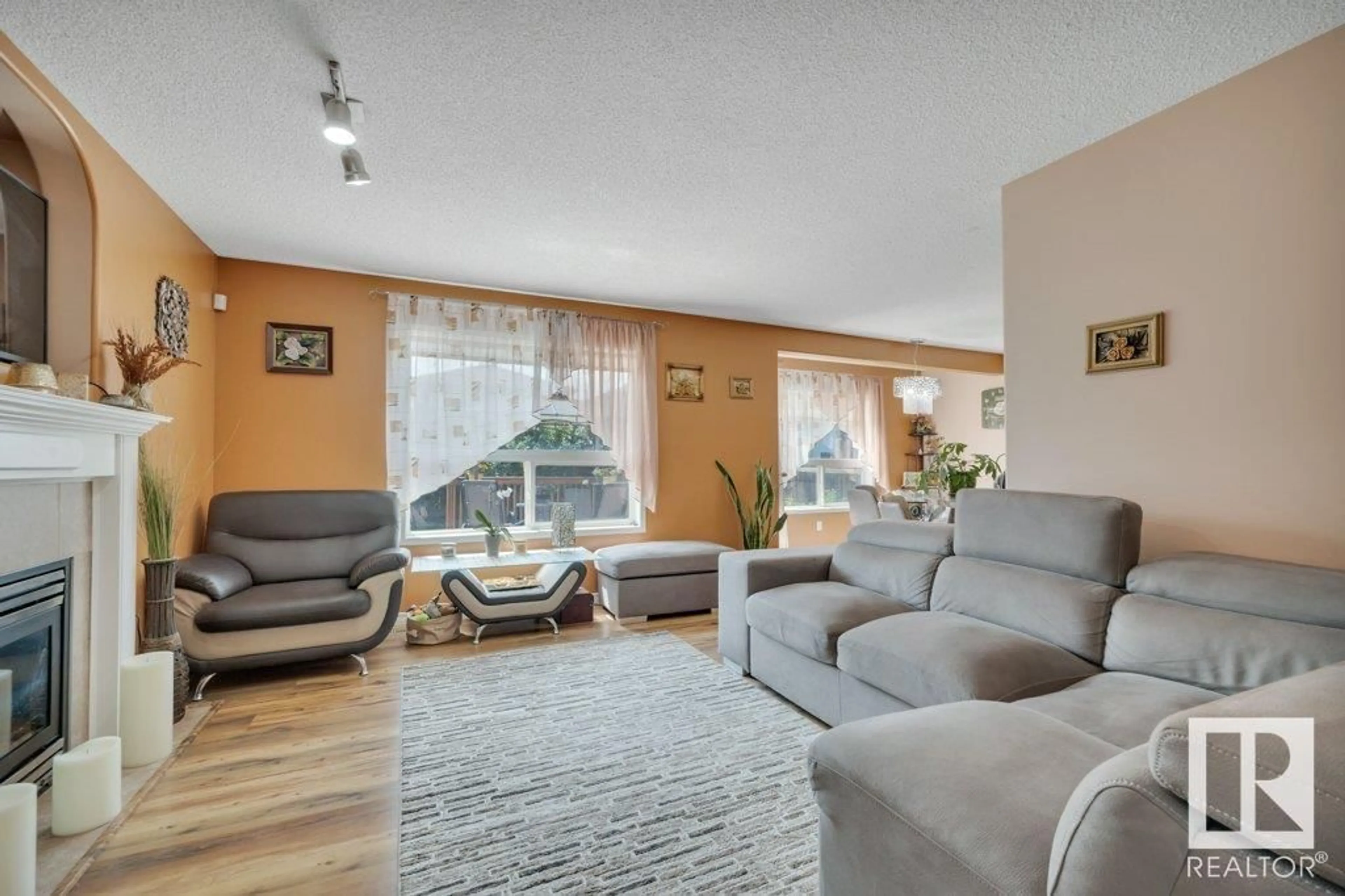 Living room with furniture, wood/laminate floor for NW - 11239 167B AV, Edmonton Alberta T5X6J6