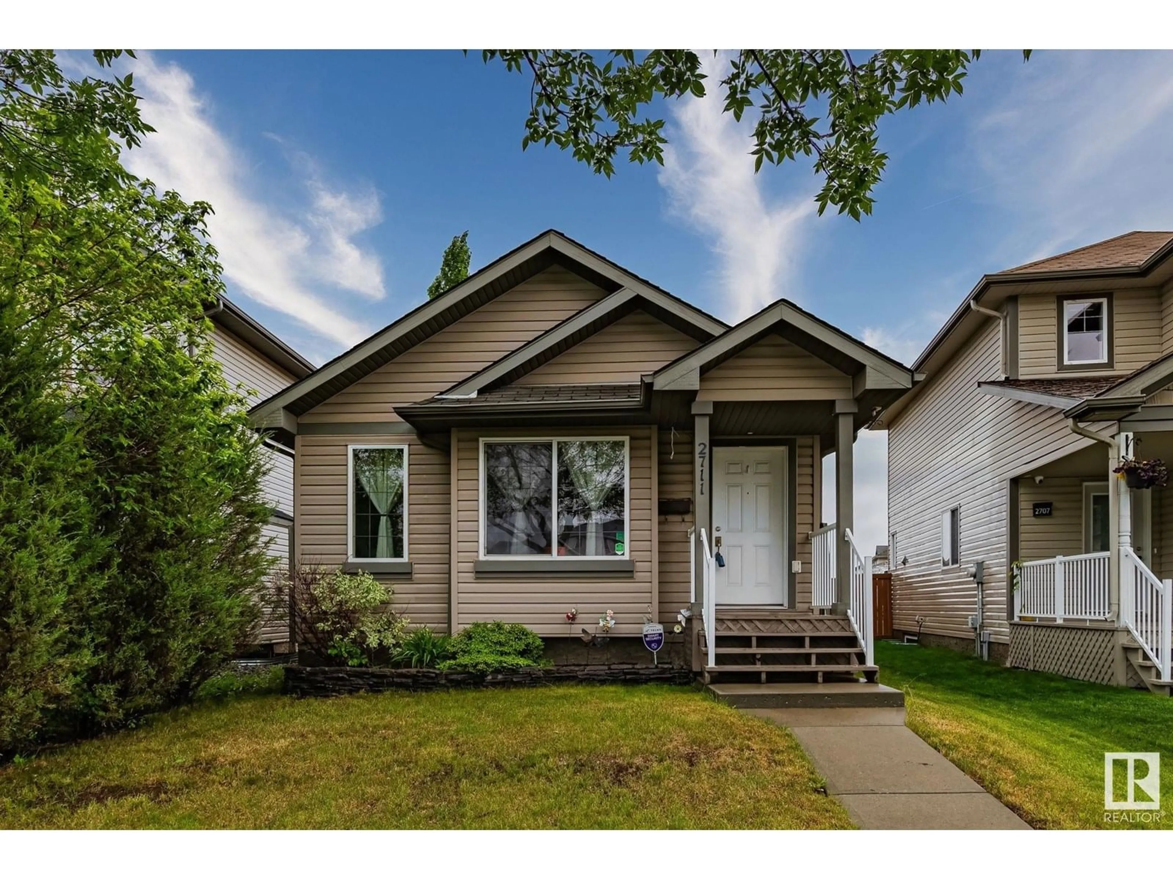 Home with vinyl exterior material, street for 2711 24 ST, Edmonton Alberta T6T0A4