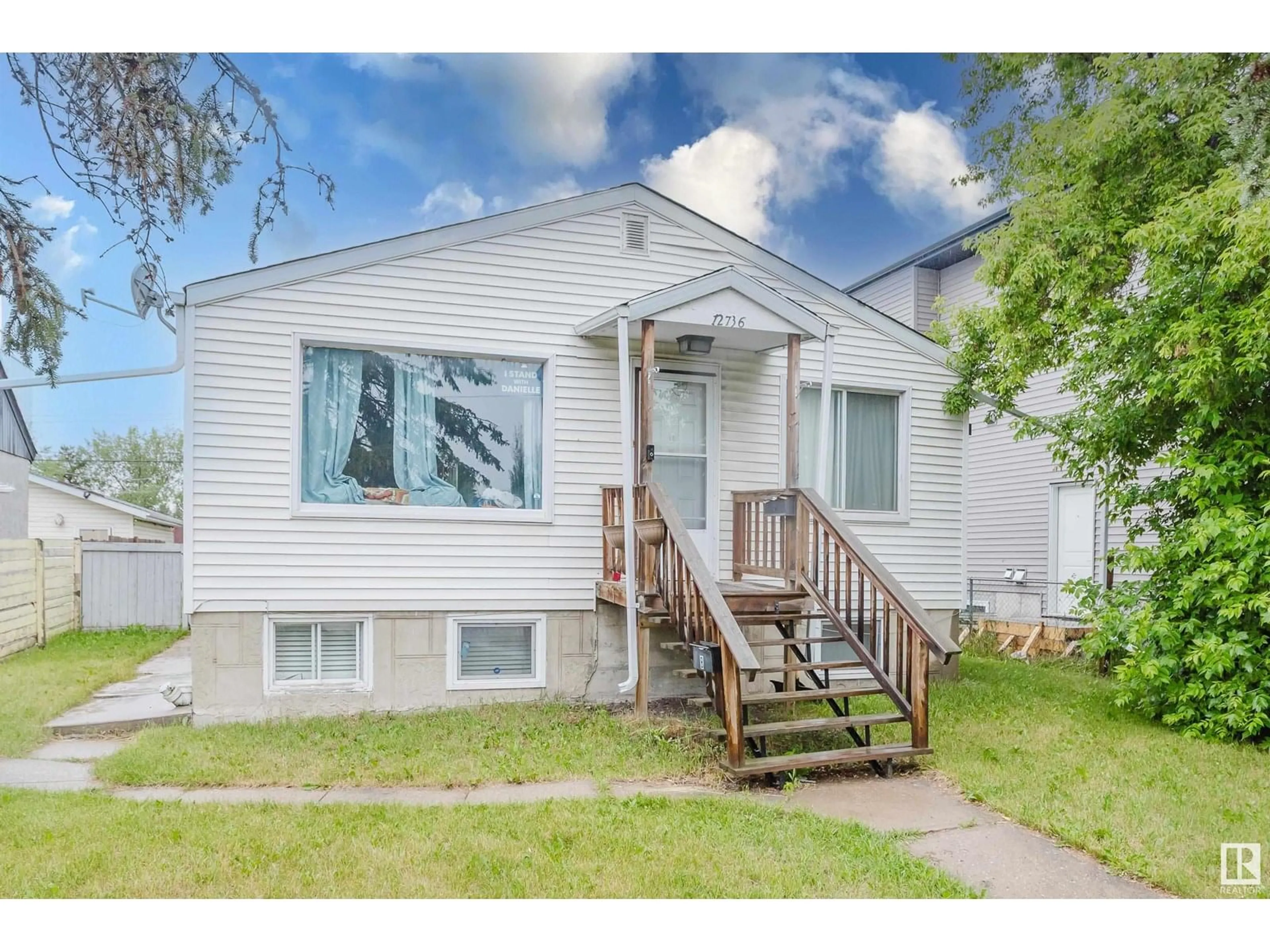 Home with vinyl exterior material, street for 12736 130 ST, Edmonton Alberta T5L1L2