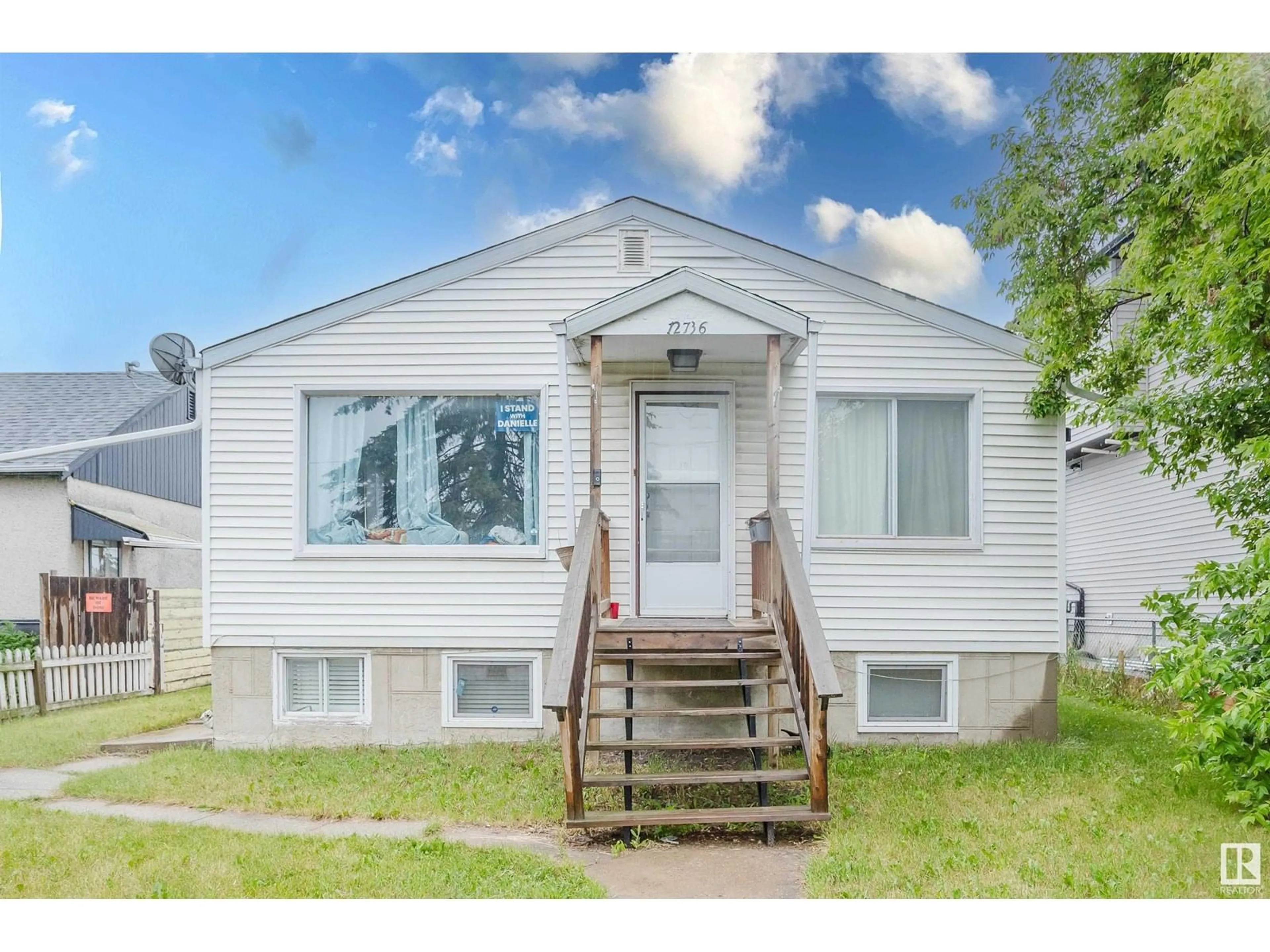 Home with vinyl exterior material, street for 12736 130 ST, Edmonton Alberta T5L1L2