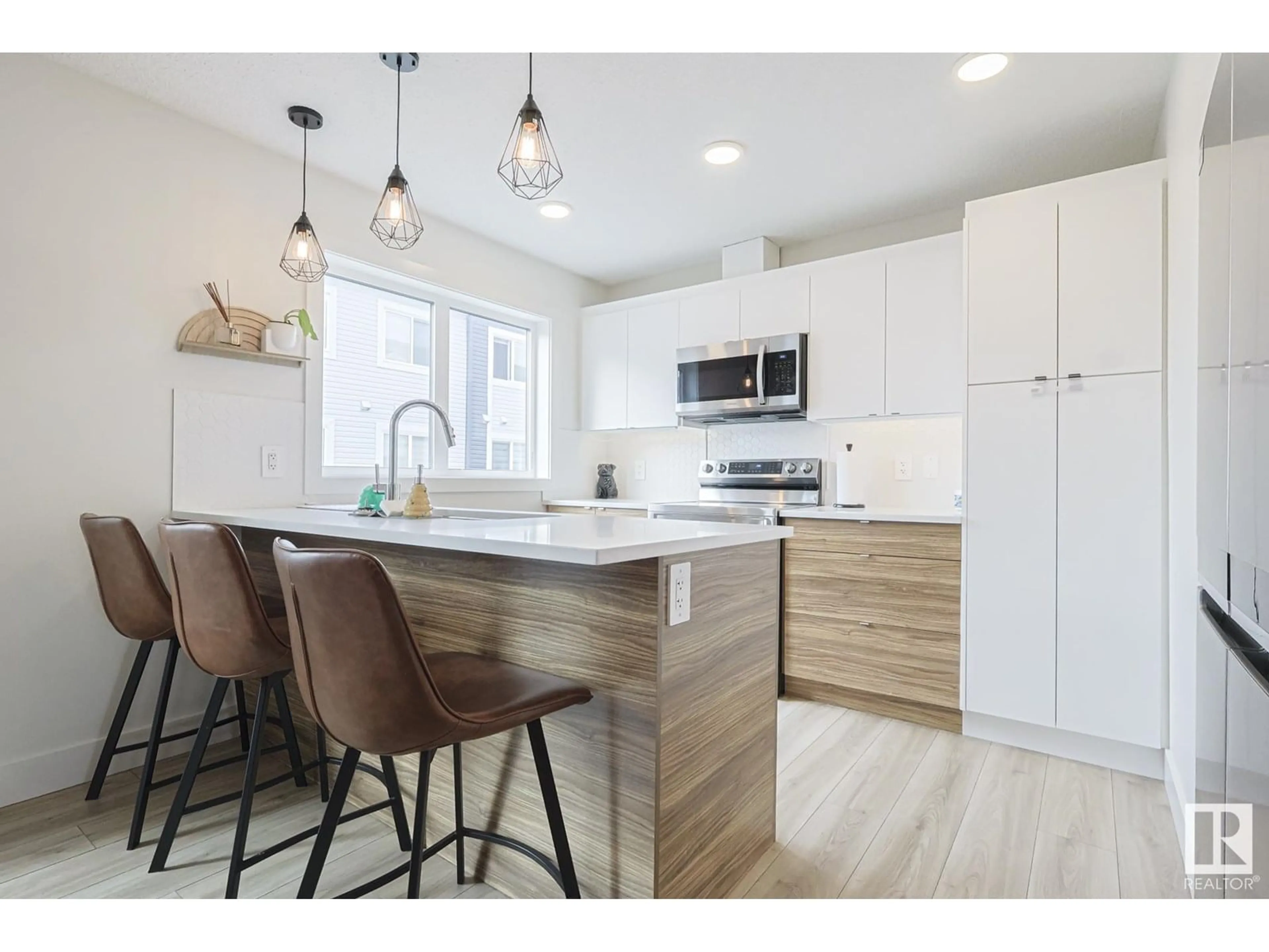 Open concept kitchen, wood/laminate floor for 72 16335 84 ST, Edmonton Alberta T5Z0S2