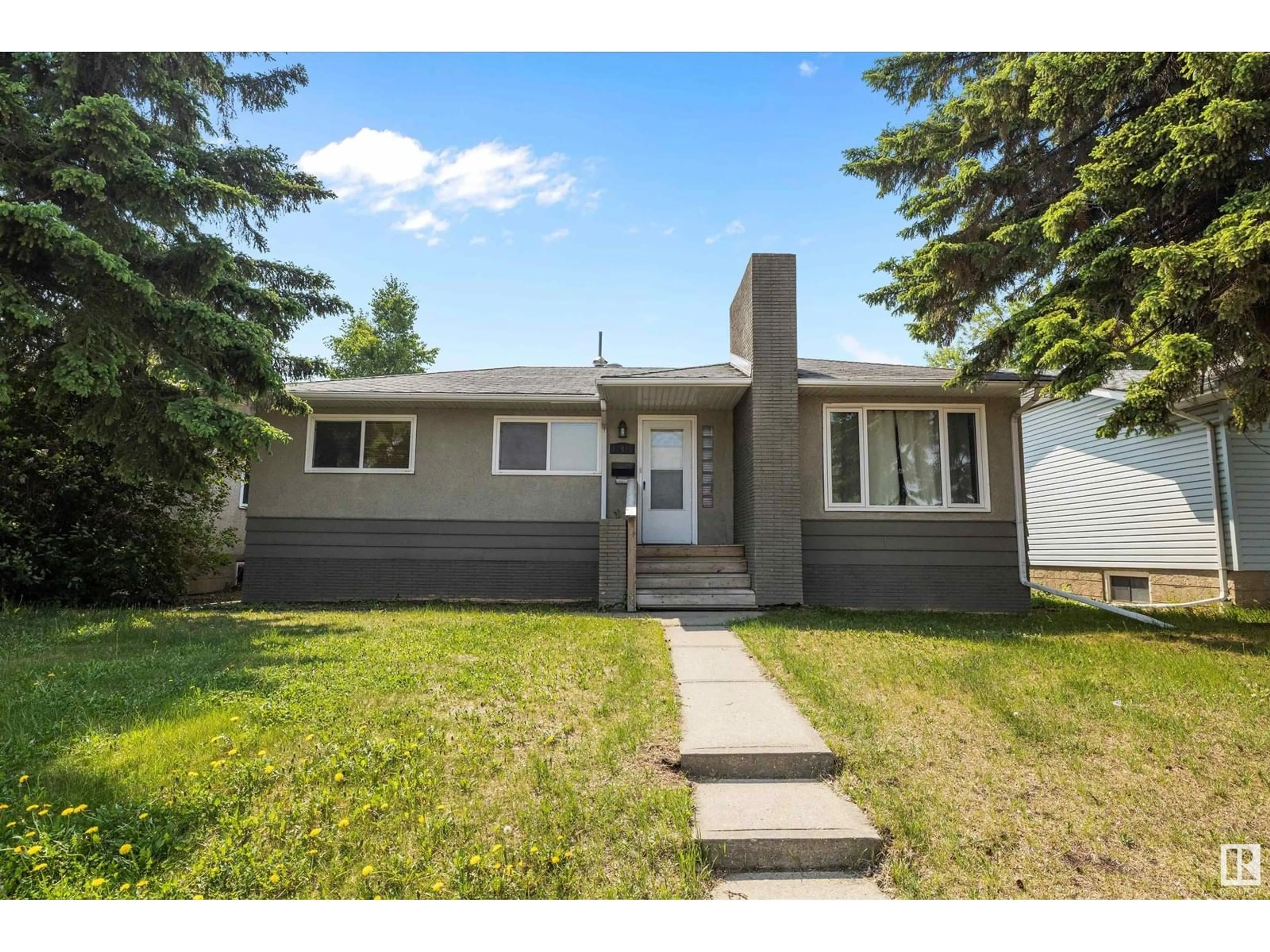 Home with vinyl exterior material, street for 12411 132 AV, Edmonton Alberta T5L3P8