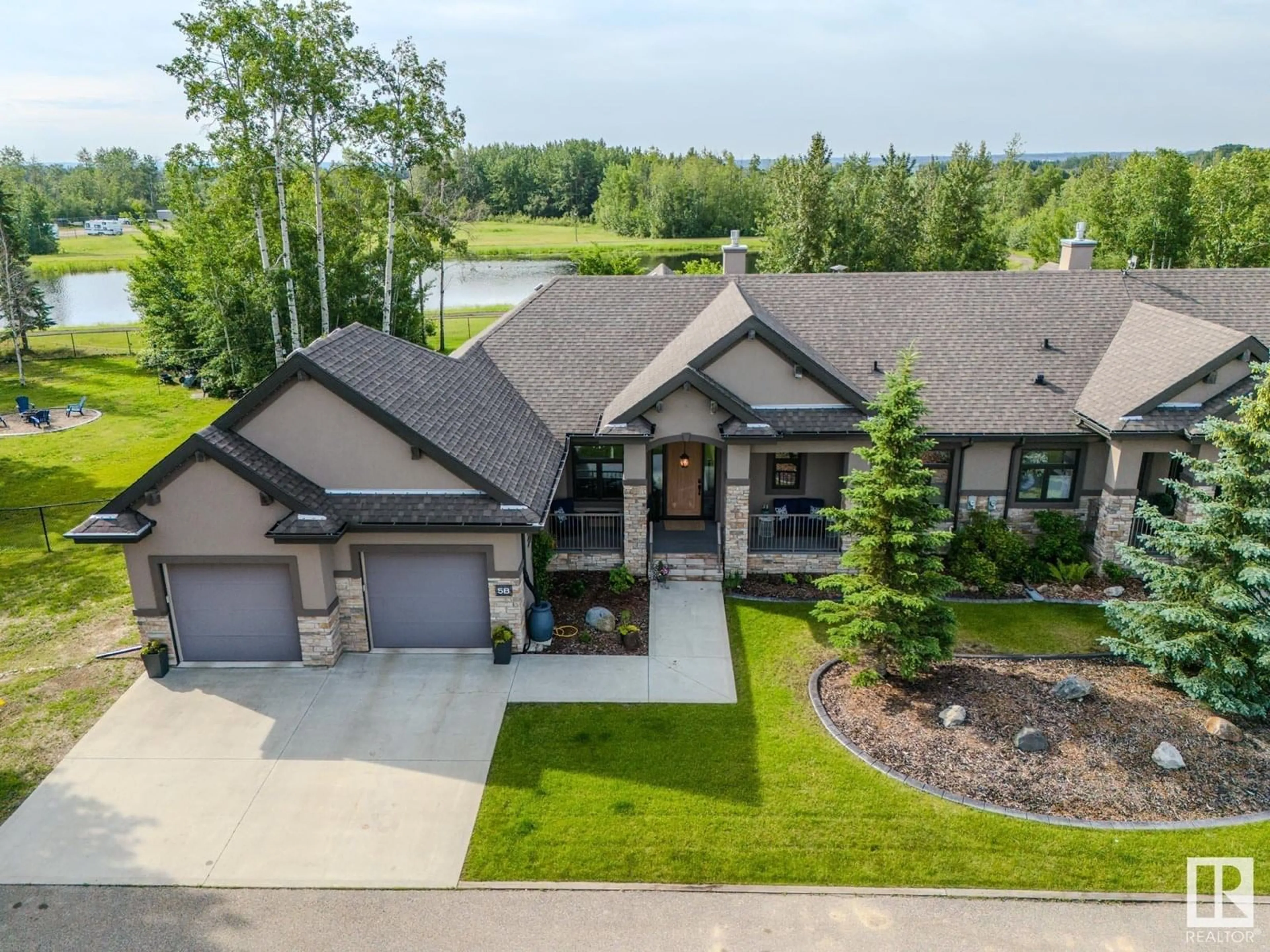 A pic from outside/outdoor area/front of a property/back of a property/a pic from drone, unknown for 5B - 53521 RGE ROAD 272, Rural Parkland County Alberta T7X3M5