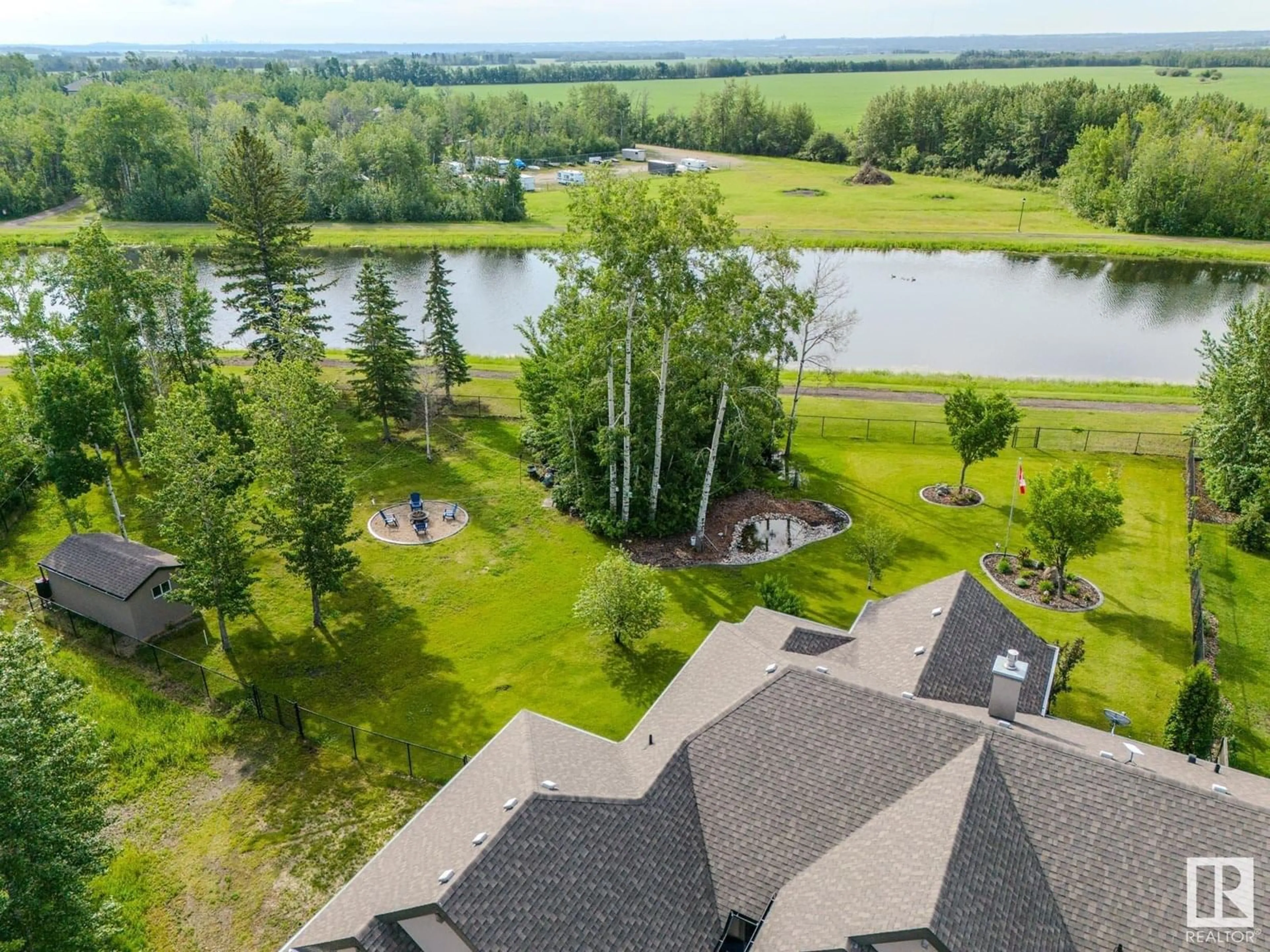 A pic from outside/outdoor area/front of a property/back of a property/a pic from drone, water/lake/river/ocean view for 5B - 53521 RGE ROAD 272, Rural Parkland County Alberta T7X3M5