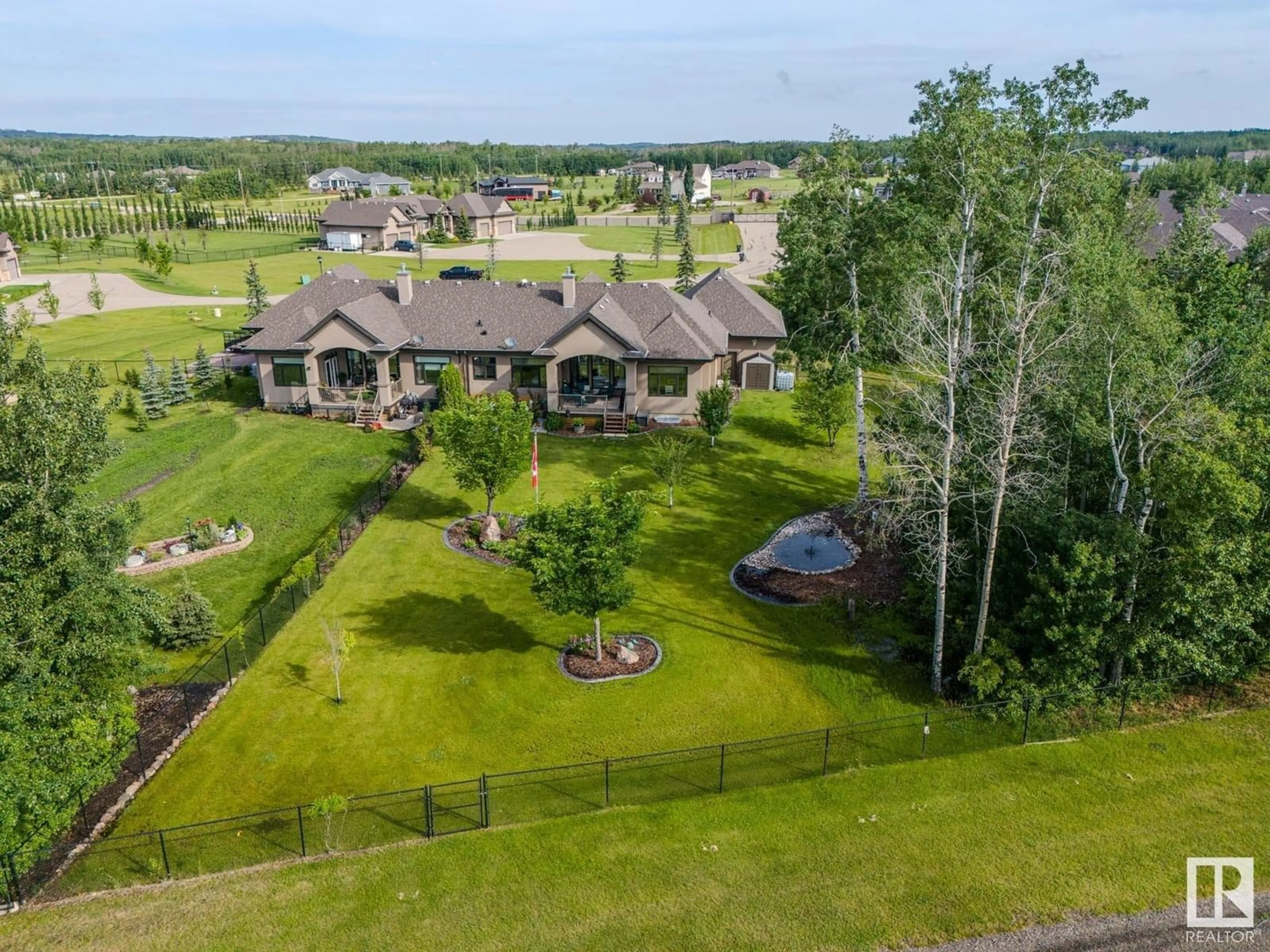 A pic from outside/outdoor area/front of a property/back of a property/a pic from drone, unknown for 5B - 53521 RGE ROAD 272, Rural Parkland County Alberta T7X3M5