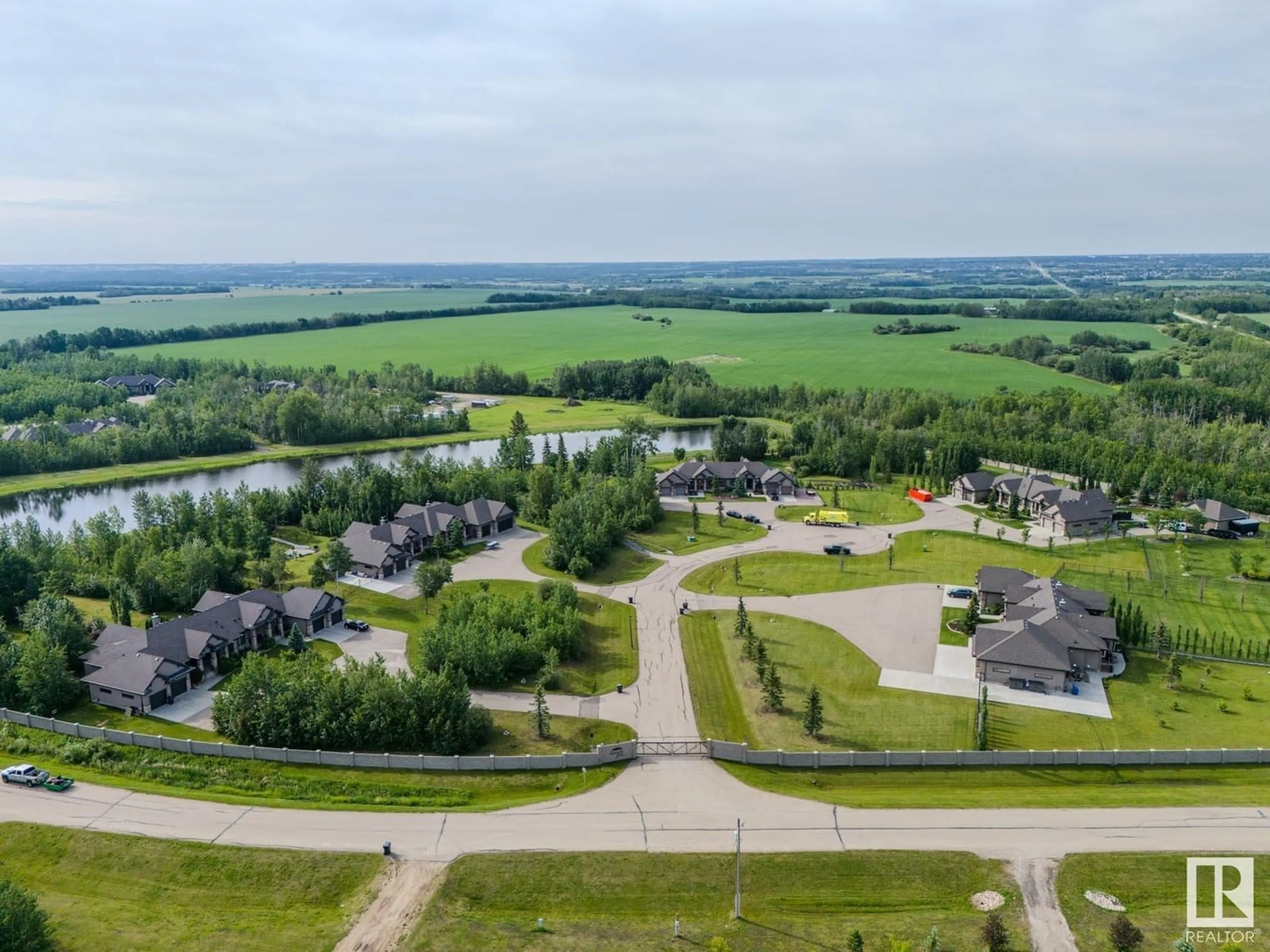 A pic from outside/outdoor area/front of a property/back of a property/a pic from drone, water/lake/river/ocean view for 5B - 53521 RGE ROAD 272, Rural Parkland County Alberta T7X3M5