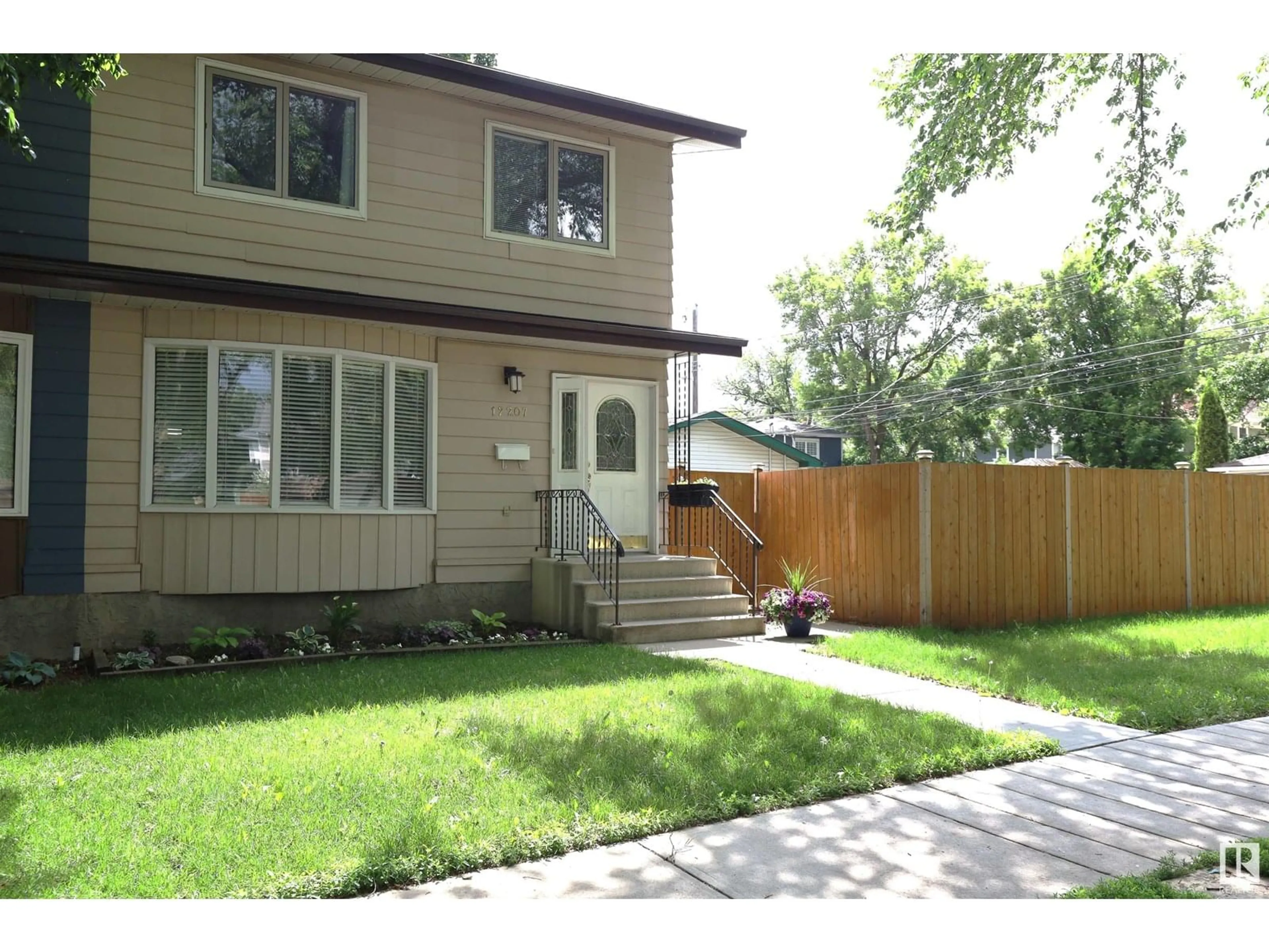 Home with vinyl exterior material, street for NW - 12207 109A AV, Edmonton Alberta T5M2H4