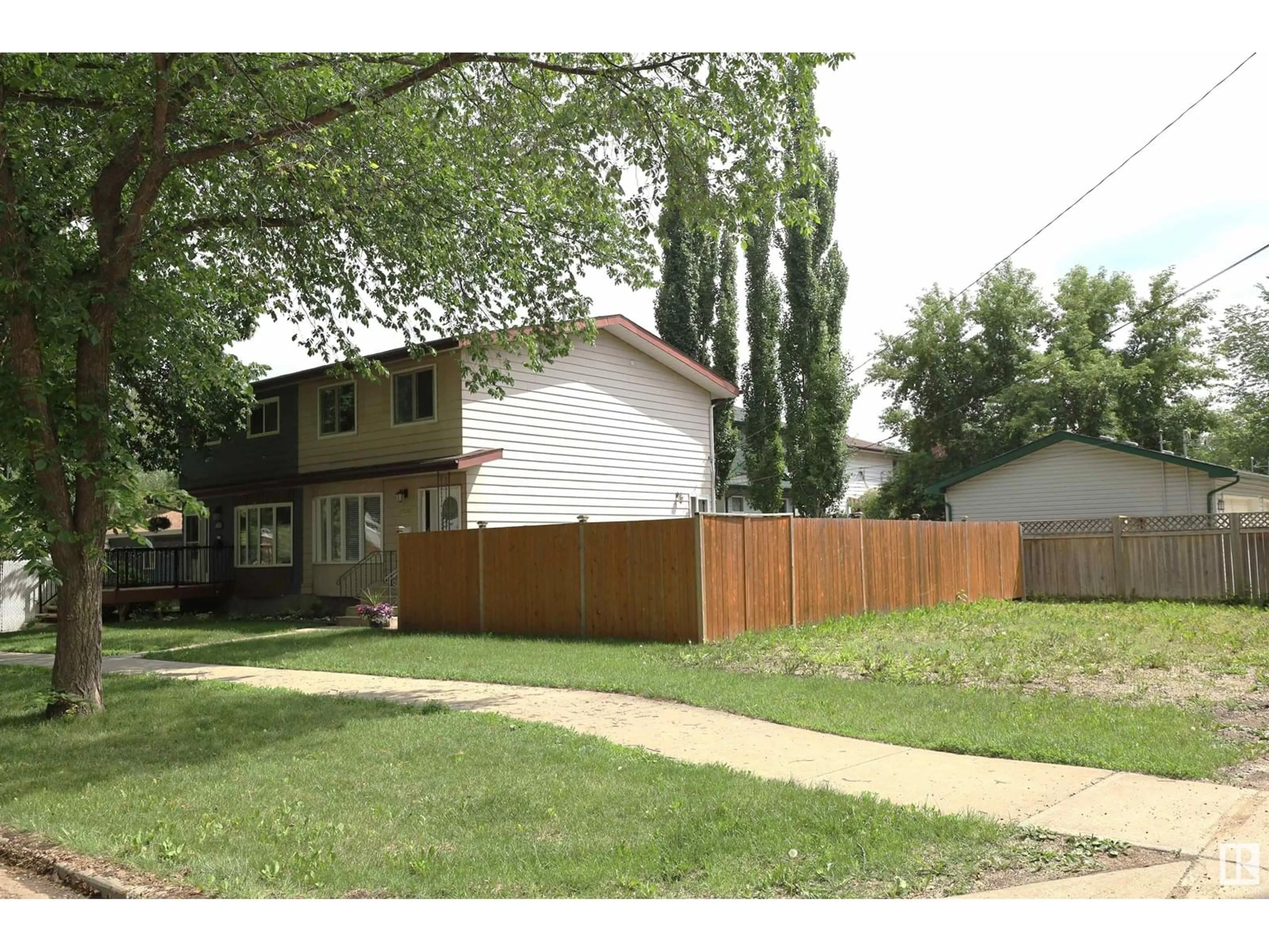 Home with vinyl exterior material, street for NW - 12207 109A AV, Edmonton Alberta T5M2H4