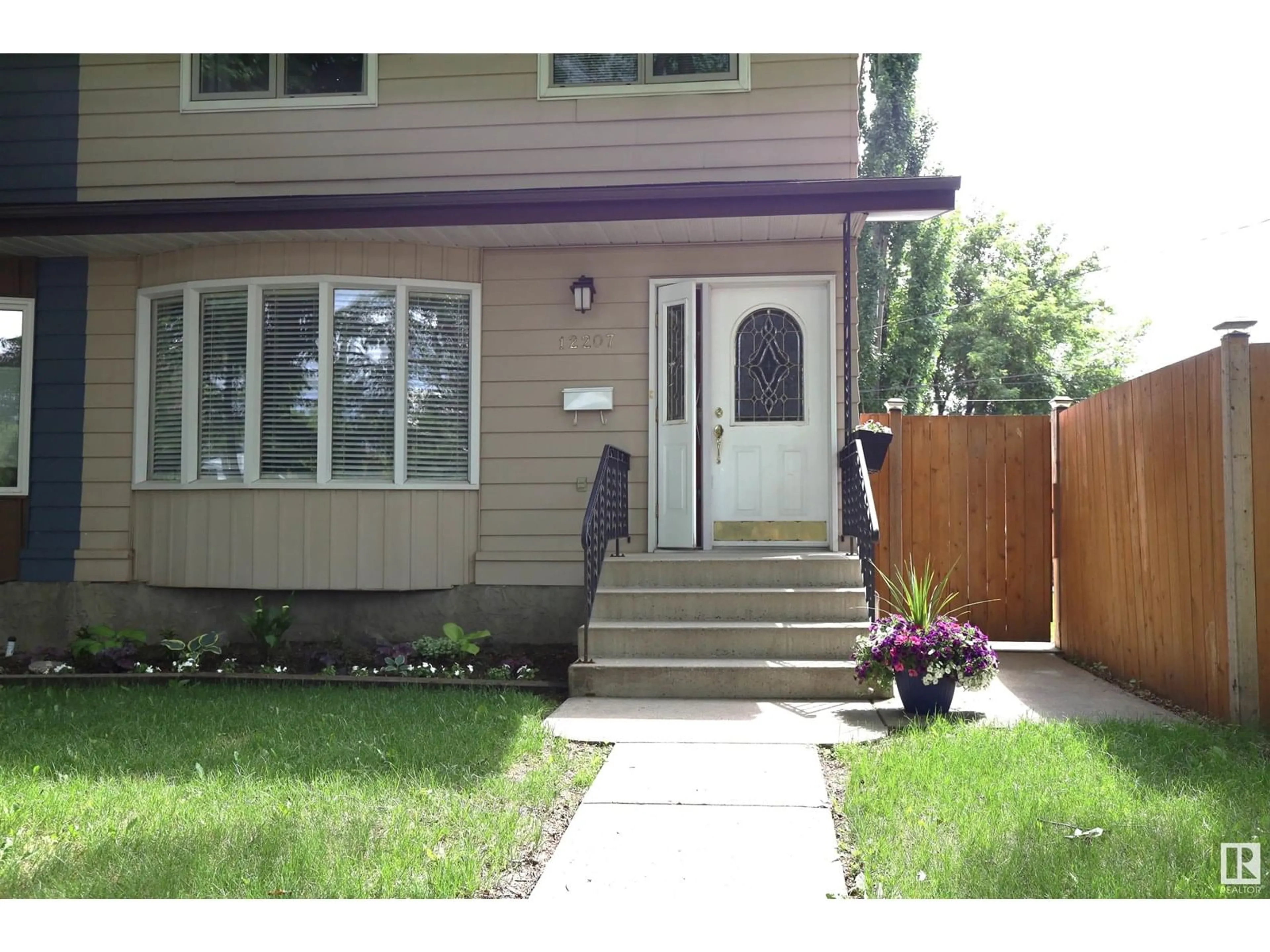 Home with vinyl exterior material, street for NW - 12207 109A AV, Edmonton Alberta T5M2H4