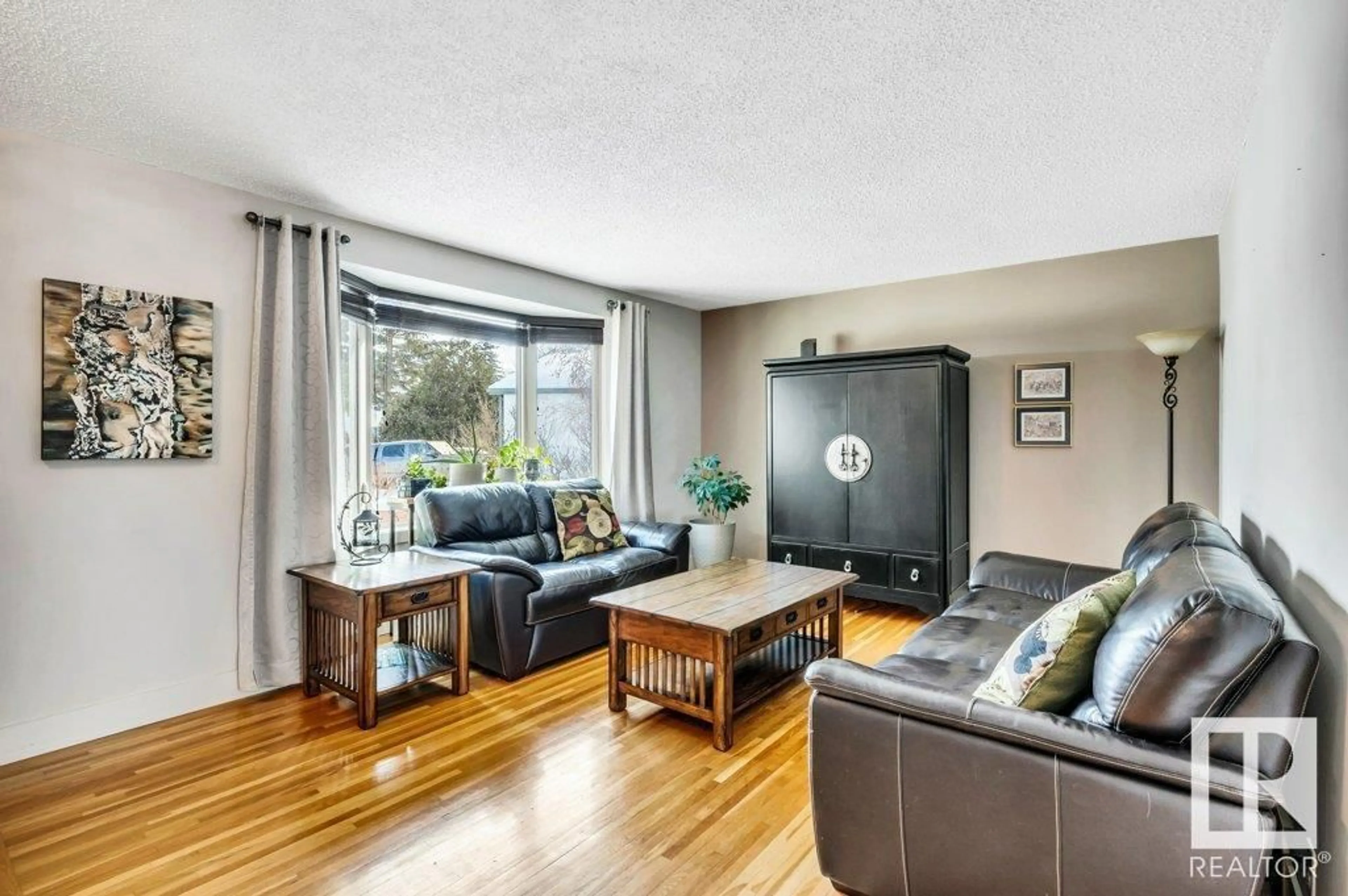 Living room with furniture, wood/laminate floor for 1704 55 ST, Edmonton Alberta T6L2C3