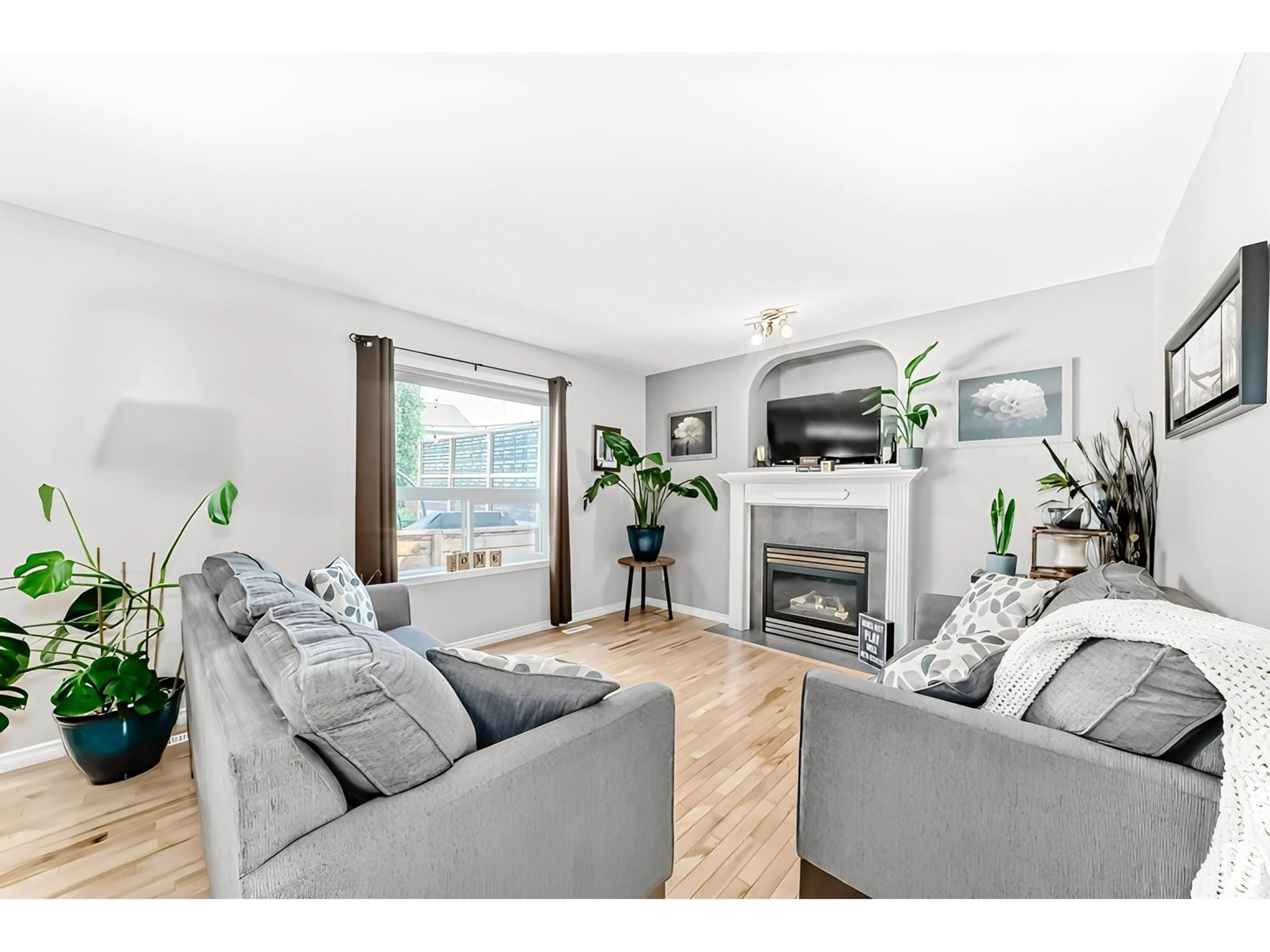 Living room with furniture, wood/laminate floor for 11832 168 AV, Edmonton Alberta T5X6K4