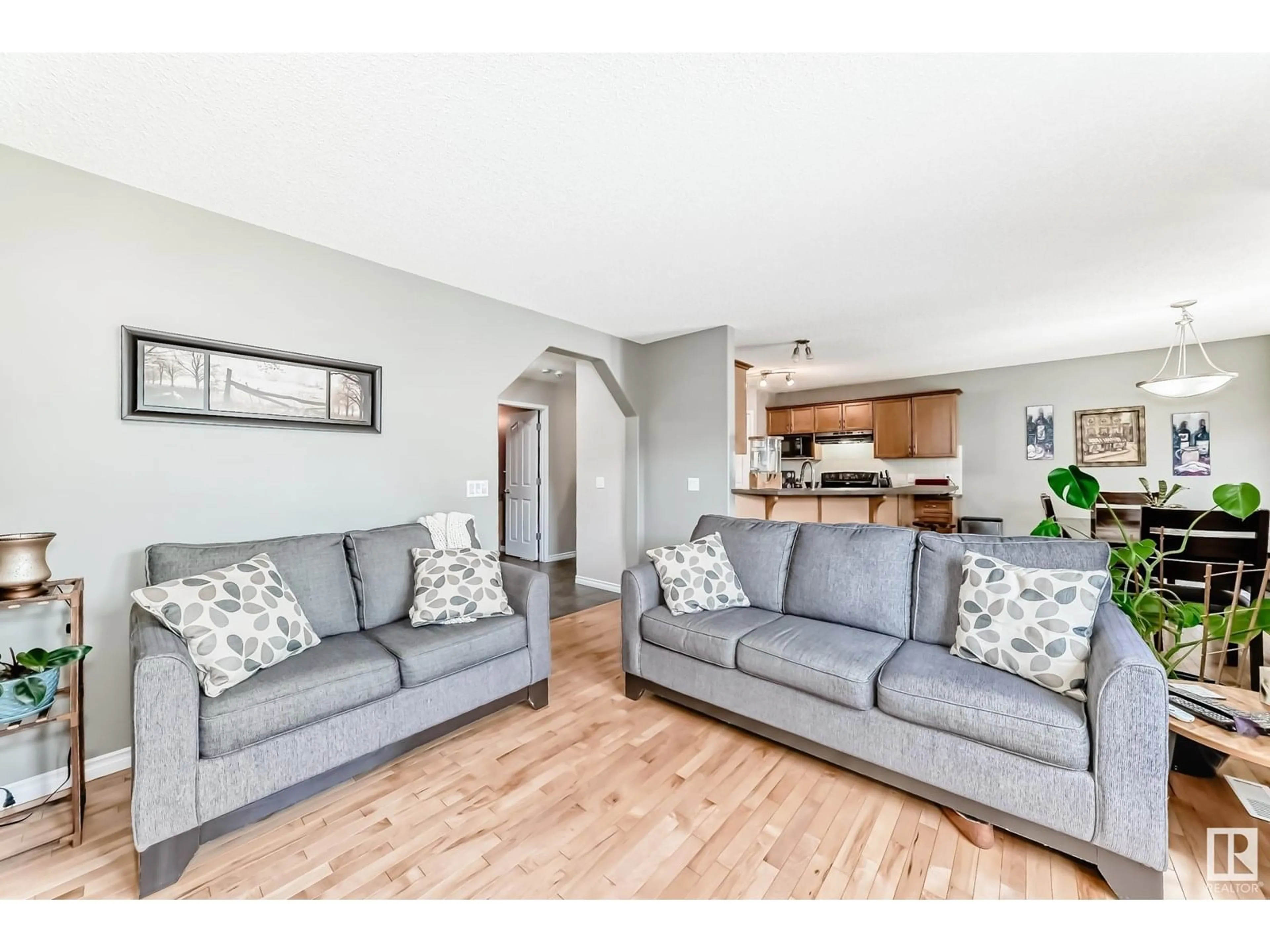 Living room with furniture, wood/laminate floor for 11832 168 AV, Edmonton Alberta T5X6K4