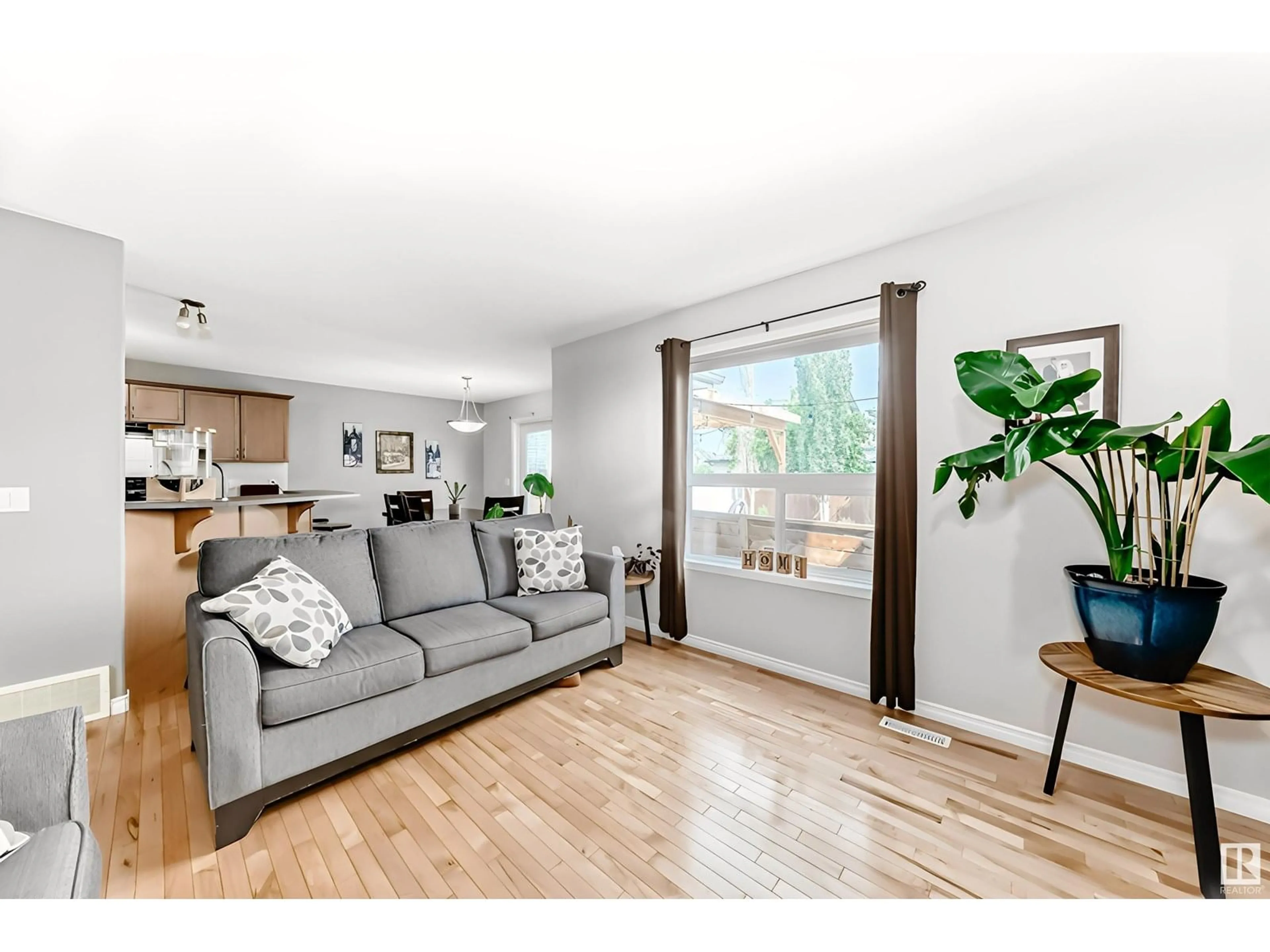 Living room with furniture, wood/laminate floor for 11832 168 AV, Edmonton Alberta T5X6K4
