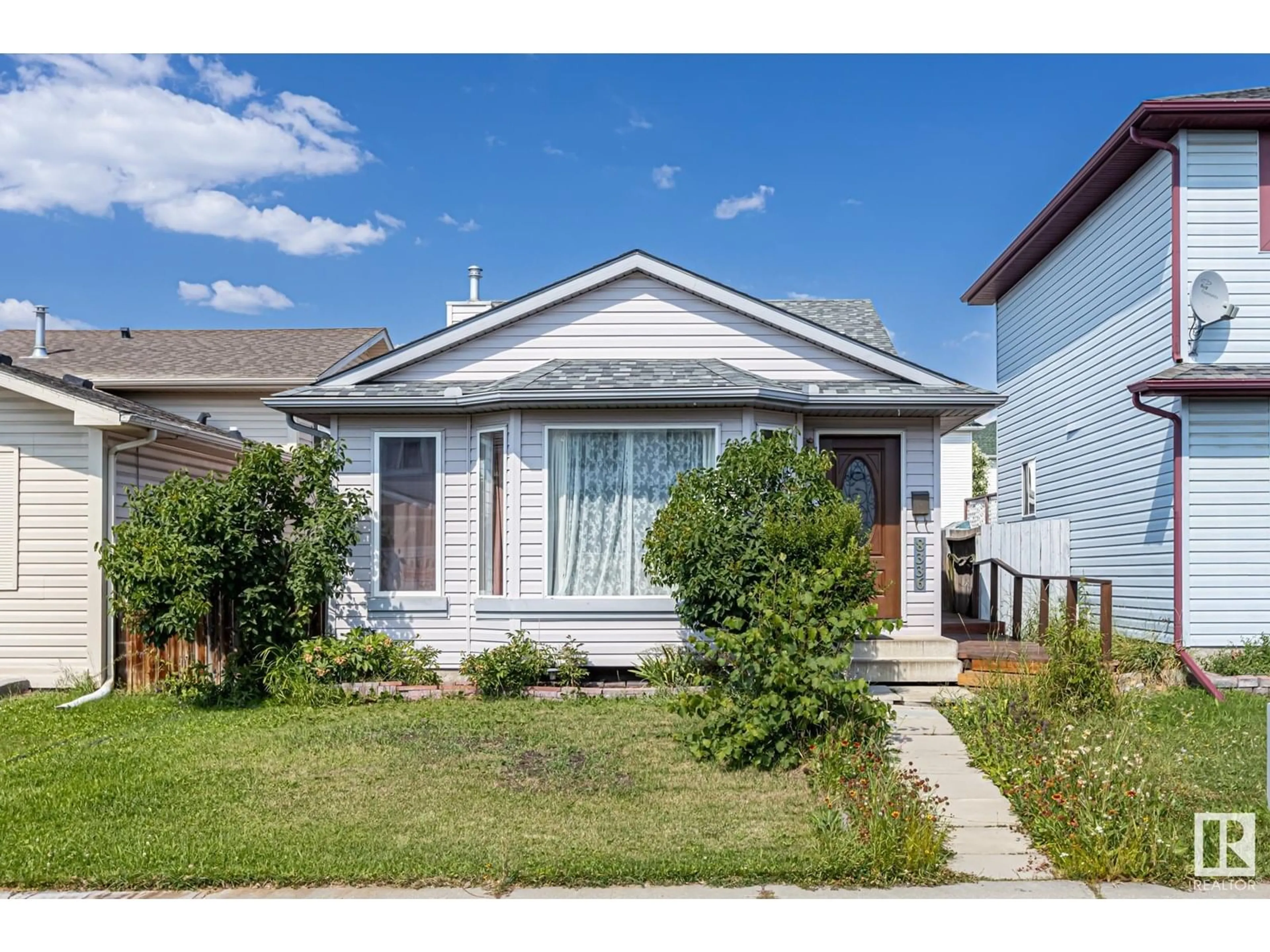 Home with vinyl exterior material, street for NW - 8336 159 AV, Edmonton Alberta T5Z3C8