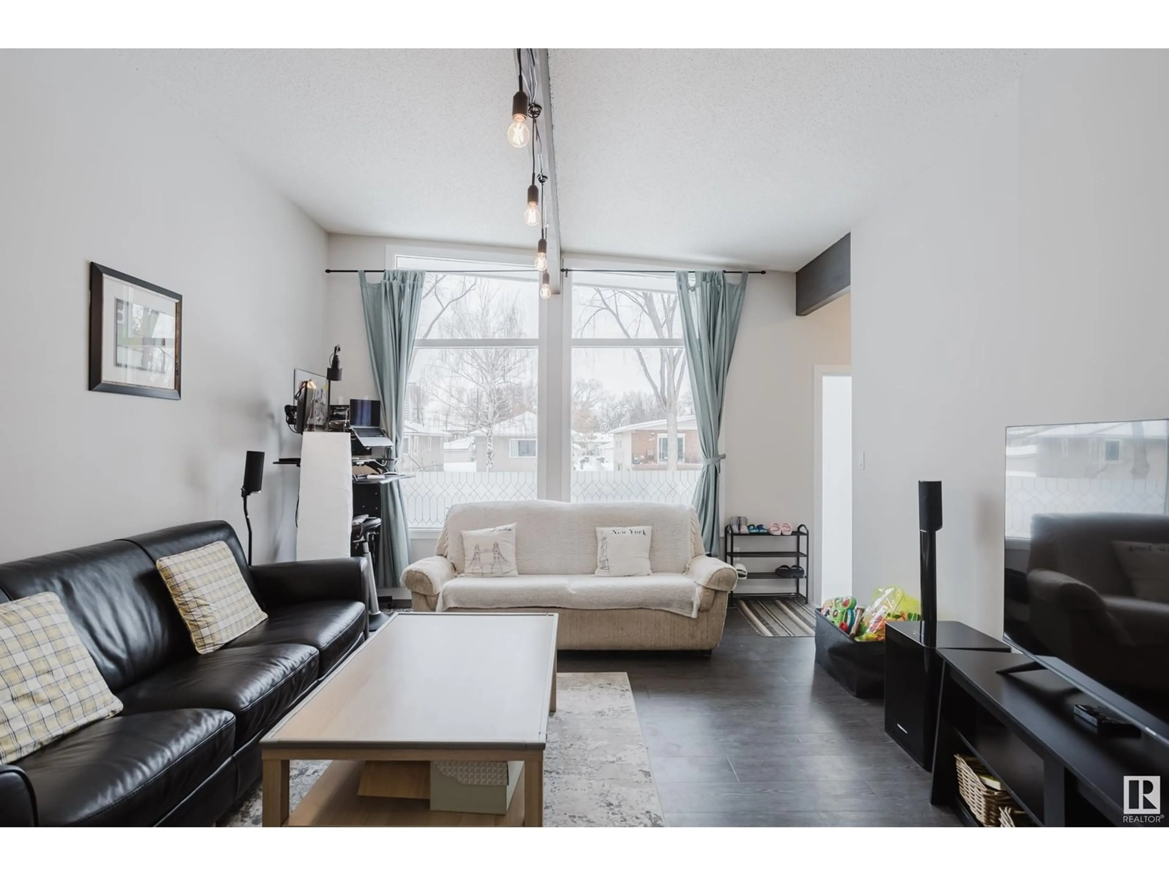Living room with furniture, wood/laminate floor for NW - 8123 8125 83 AV, Edmonton Alberta T6C1A7