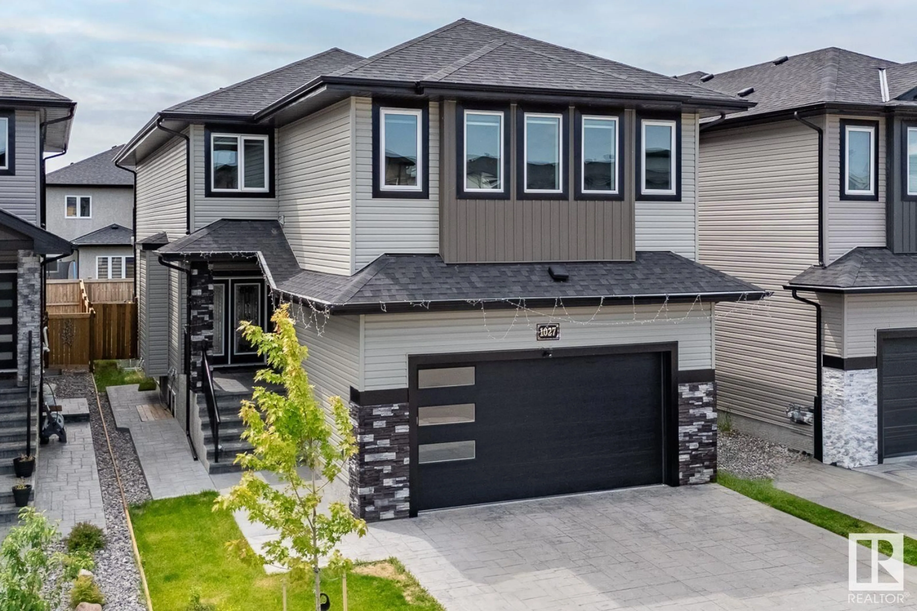 Home with vinyl exterior material, street for 1027 150 AV, Edmonton Alberta T5Y4C1