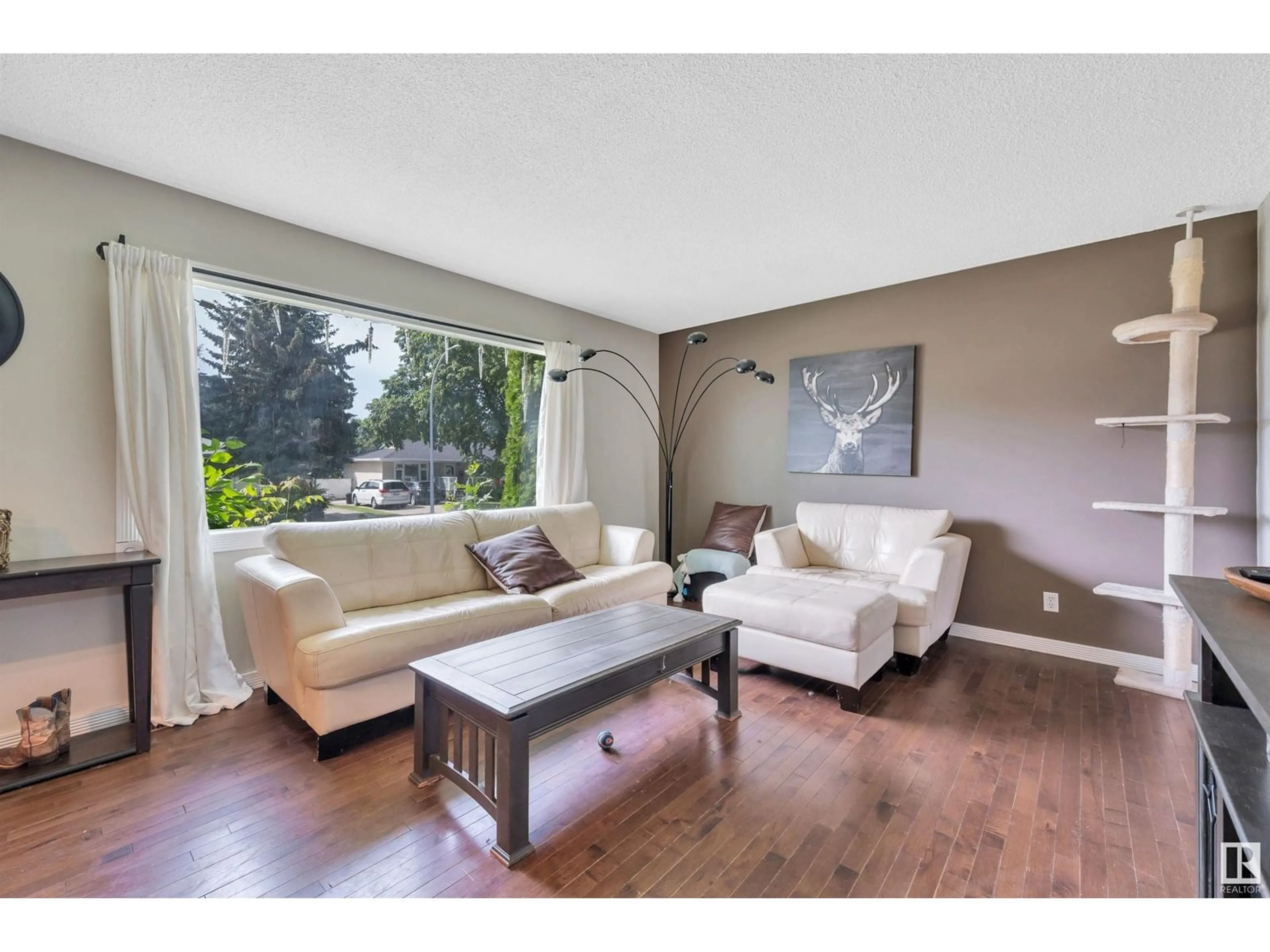 Living room with furniture, wood/laminate floor for 16 LARK ST, Sherwood Park Alberta T8A0J3