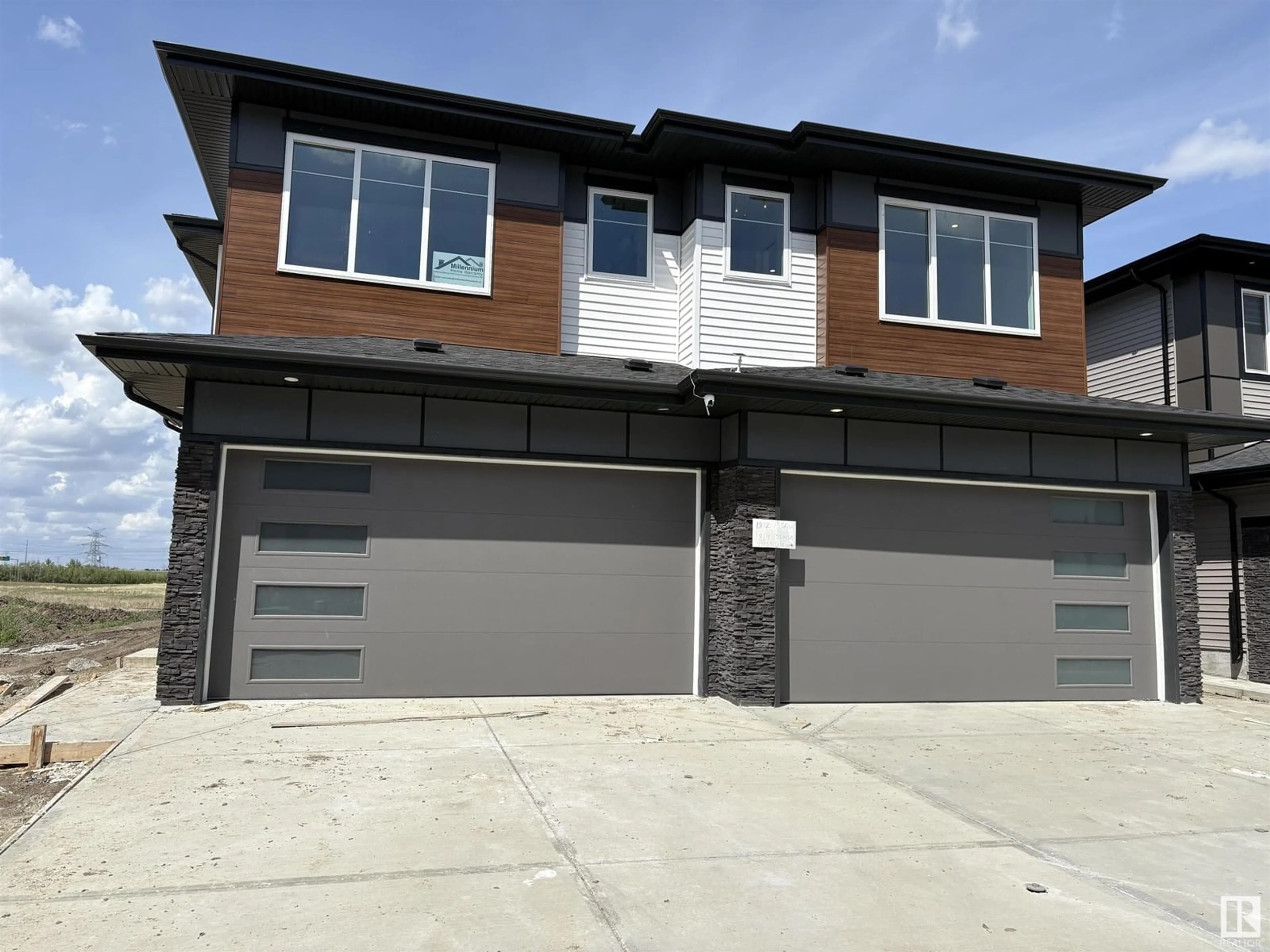 Home with brick exterior material, street for NW - 1814 155 AV, Edmonton Alberta T5Y4H8