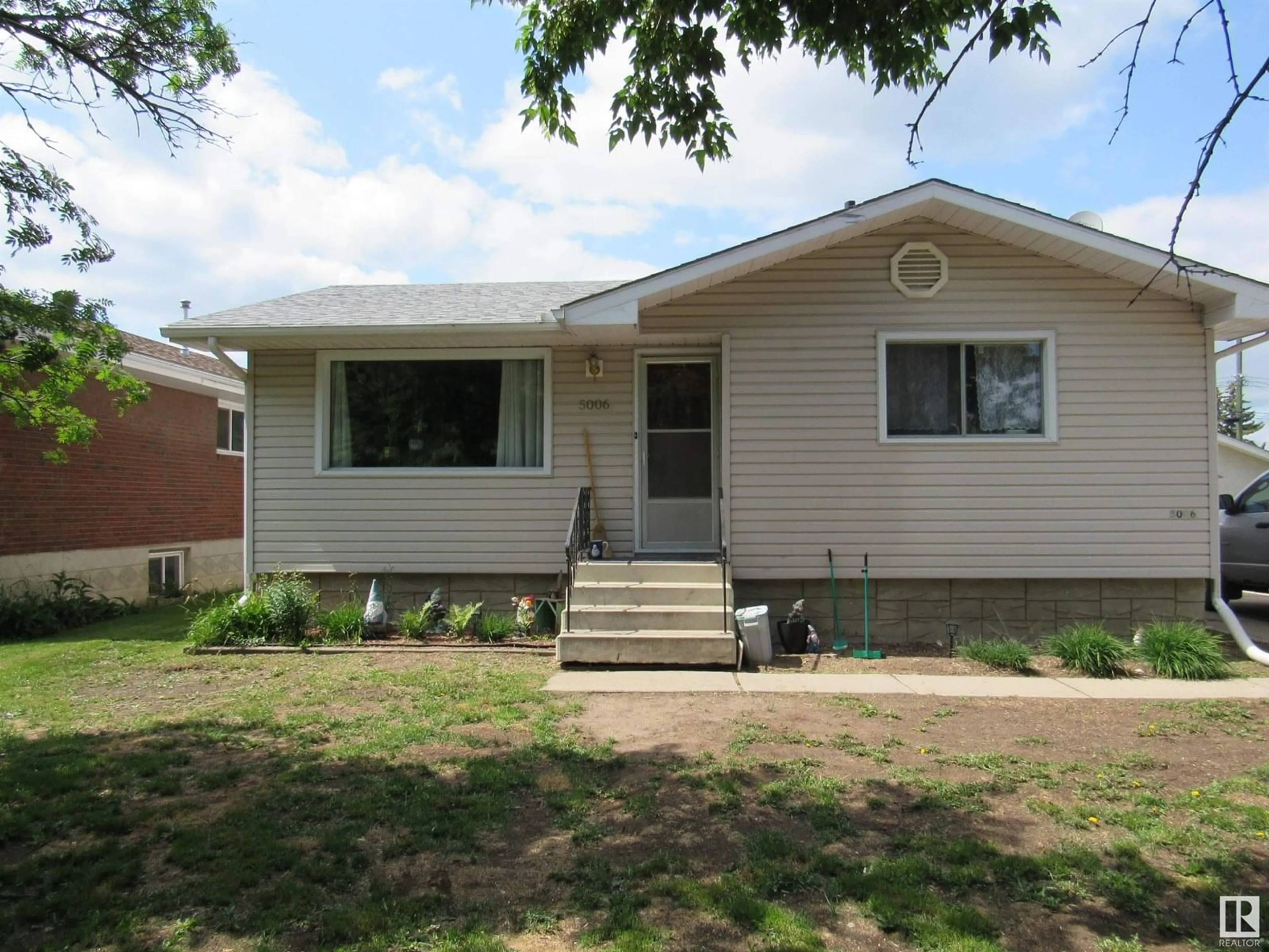 Home with vinyl exterior material, street for 5006 53 ST, Barrhead Alberta T7N1L1