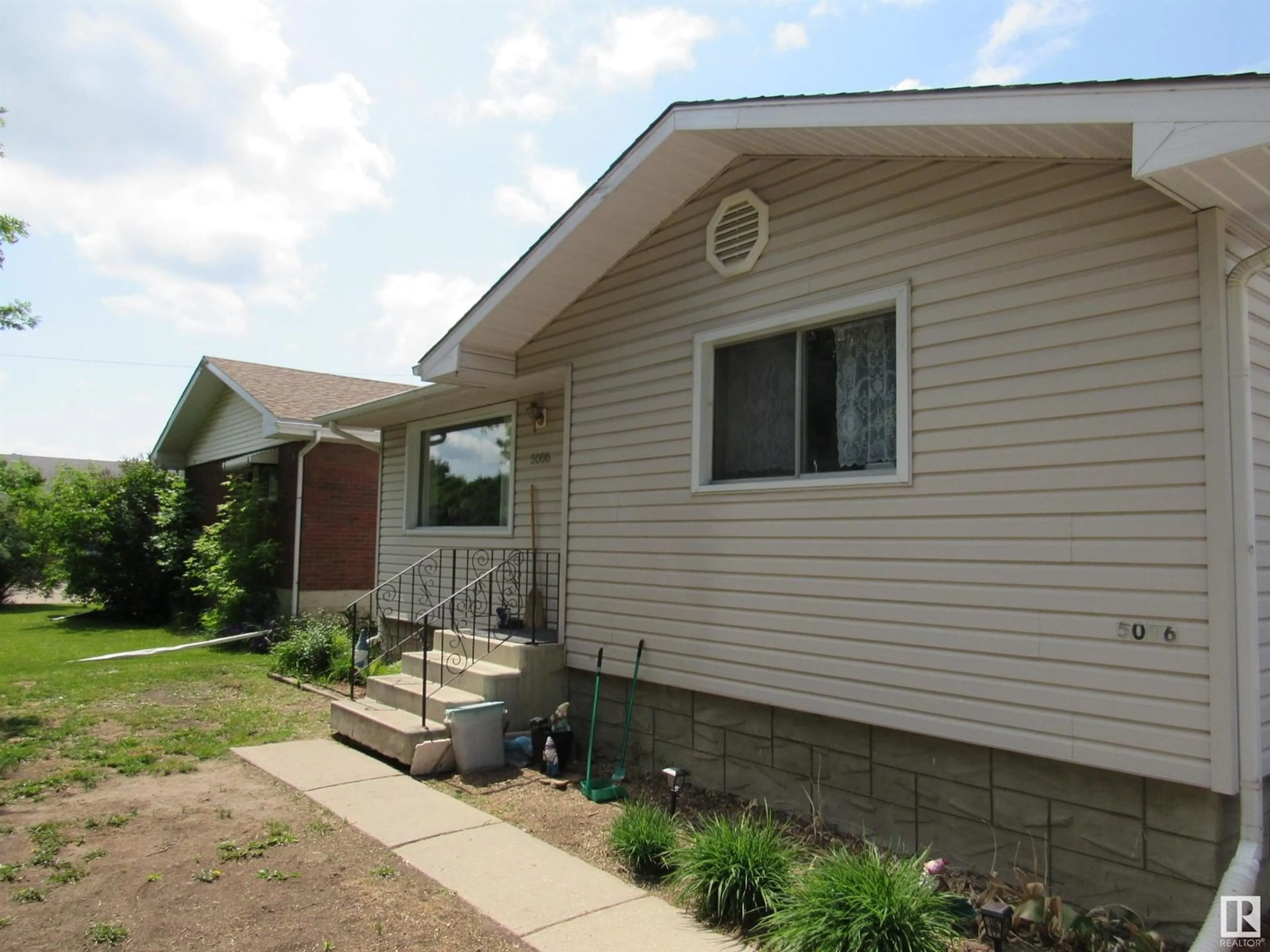 Home with vinyl exterior material, street for 5006 53 ST, Barrhead Alberta T7N1L1