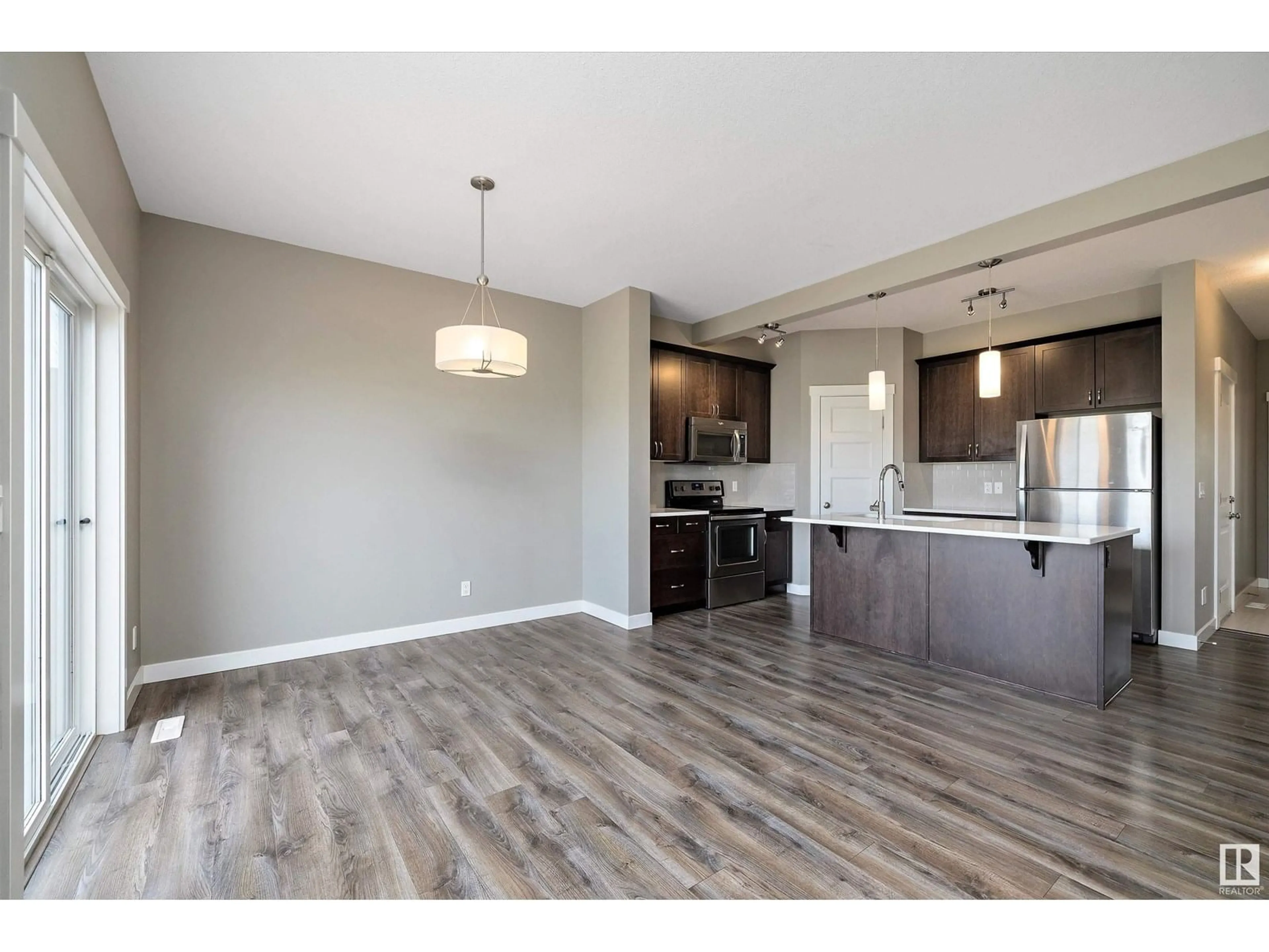 Open concept kitchen, wood/laminate floor for 58 HAZELWOOD LN, Spruce Grove Alberta T7X0R7
