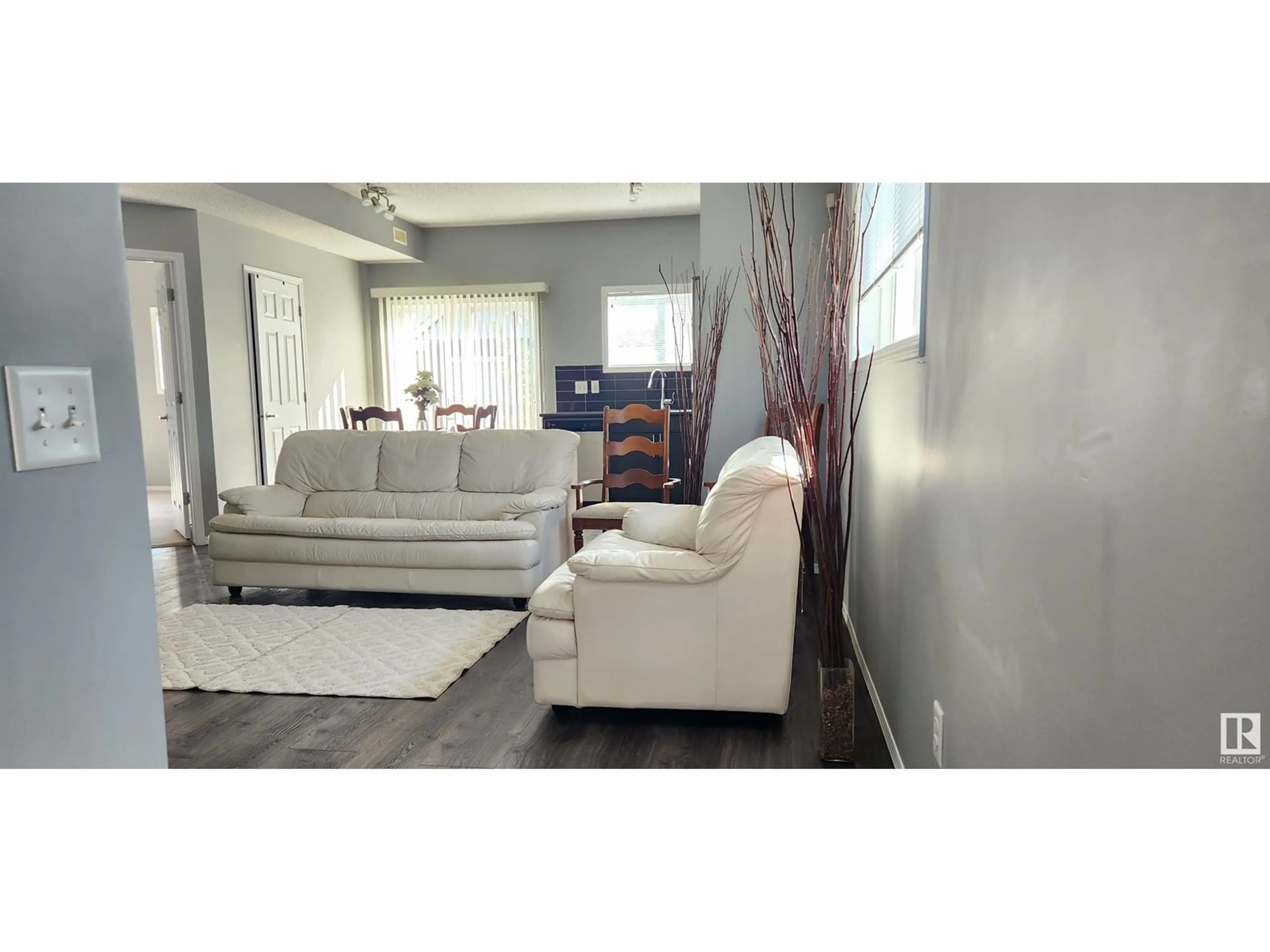 Living room with furniture, wood/laminate floor for 6520 2 AV SW, Edmonton Alberta T6X1S4