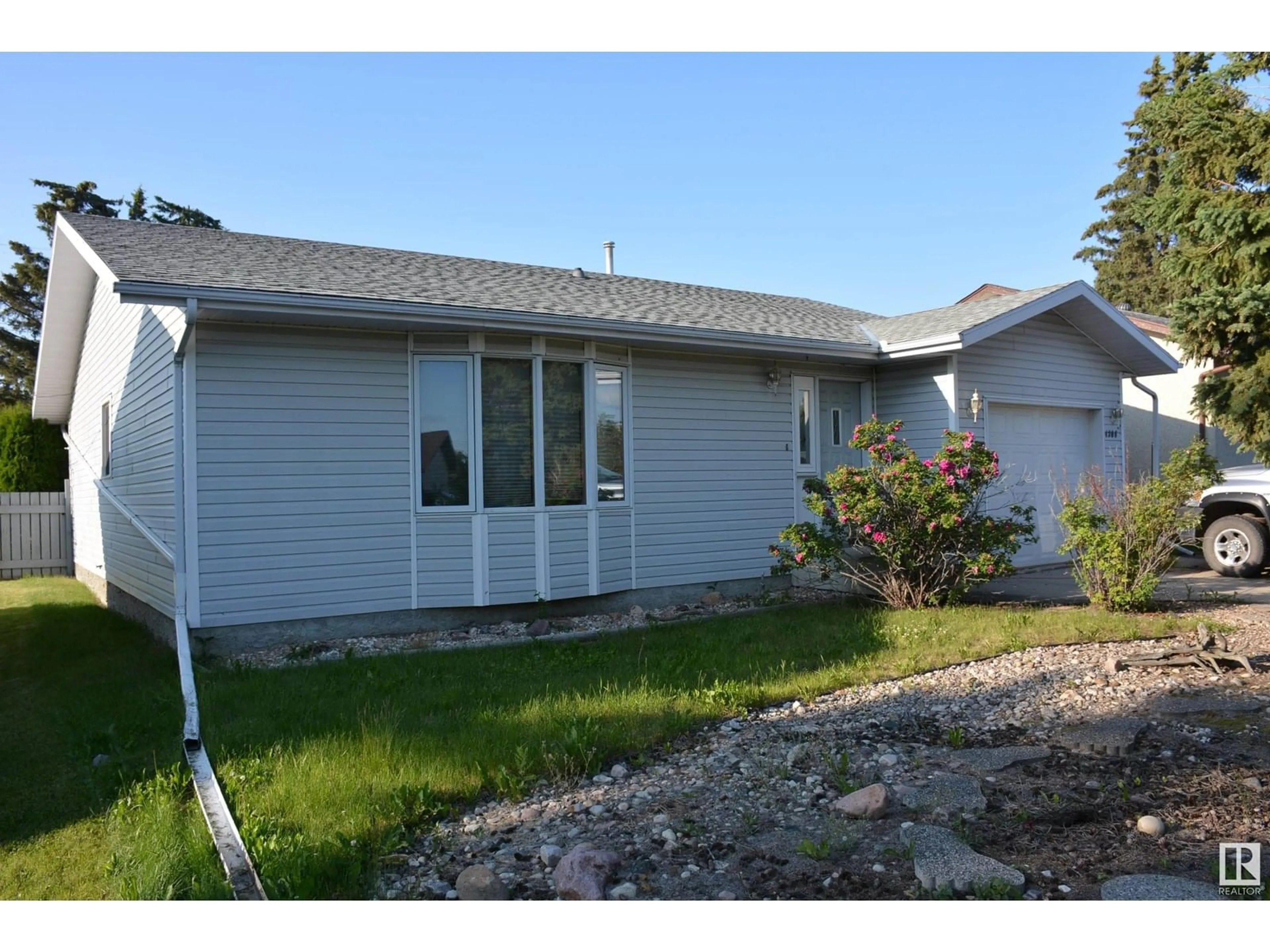 Home with vinyl exterior material, street for 4308 54 AV, Barrhead Alberta T7N1J9