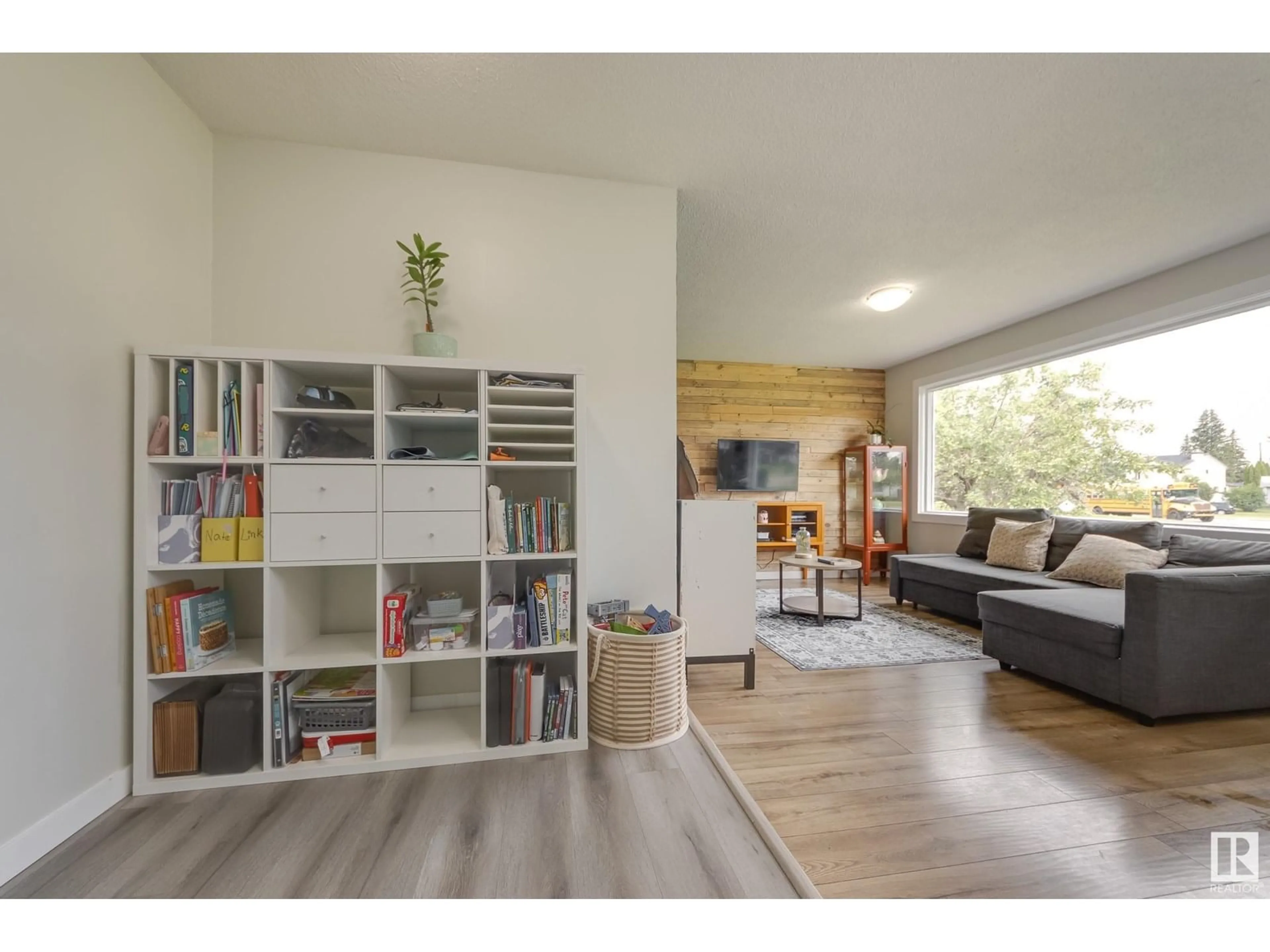 Living room with furniture, wood/laminate floor for 13503 132 AV, Edmonton Alberta T5L3R6