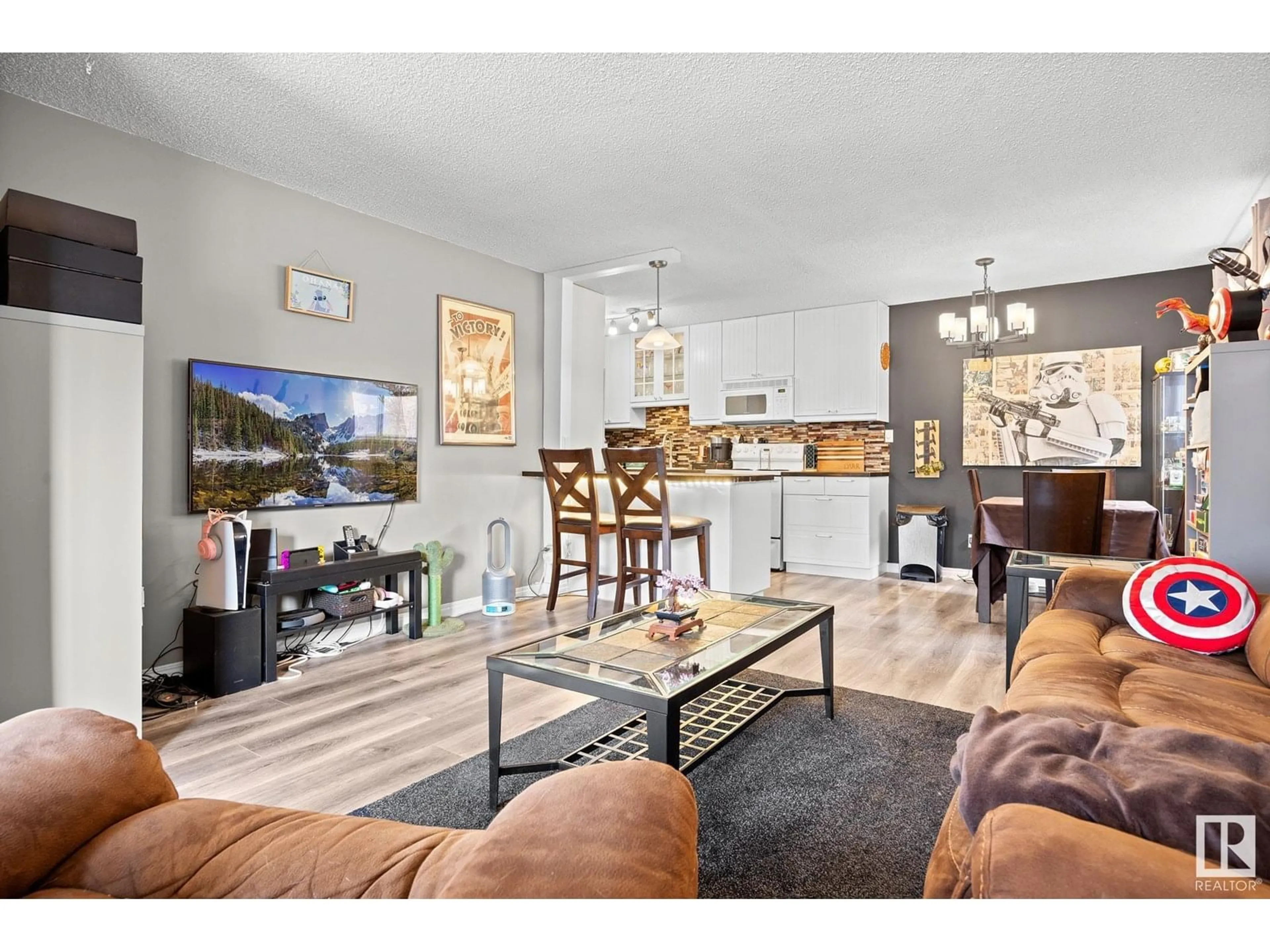 Living room with furniture, wood/laminate floor for 10434 76 AV, Edmonton Alberta T6E1L1