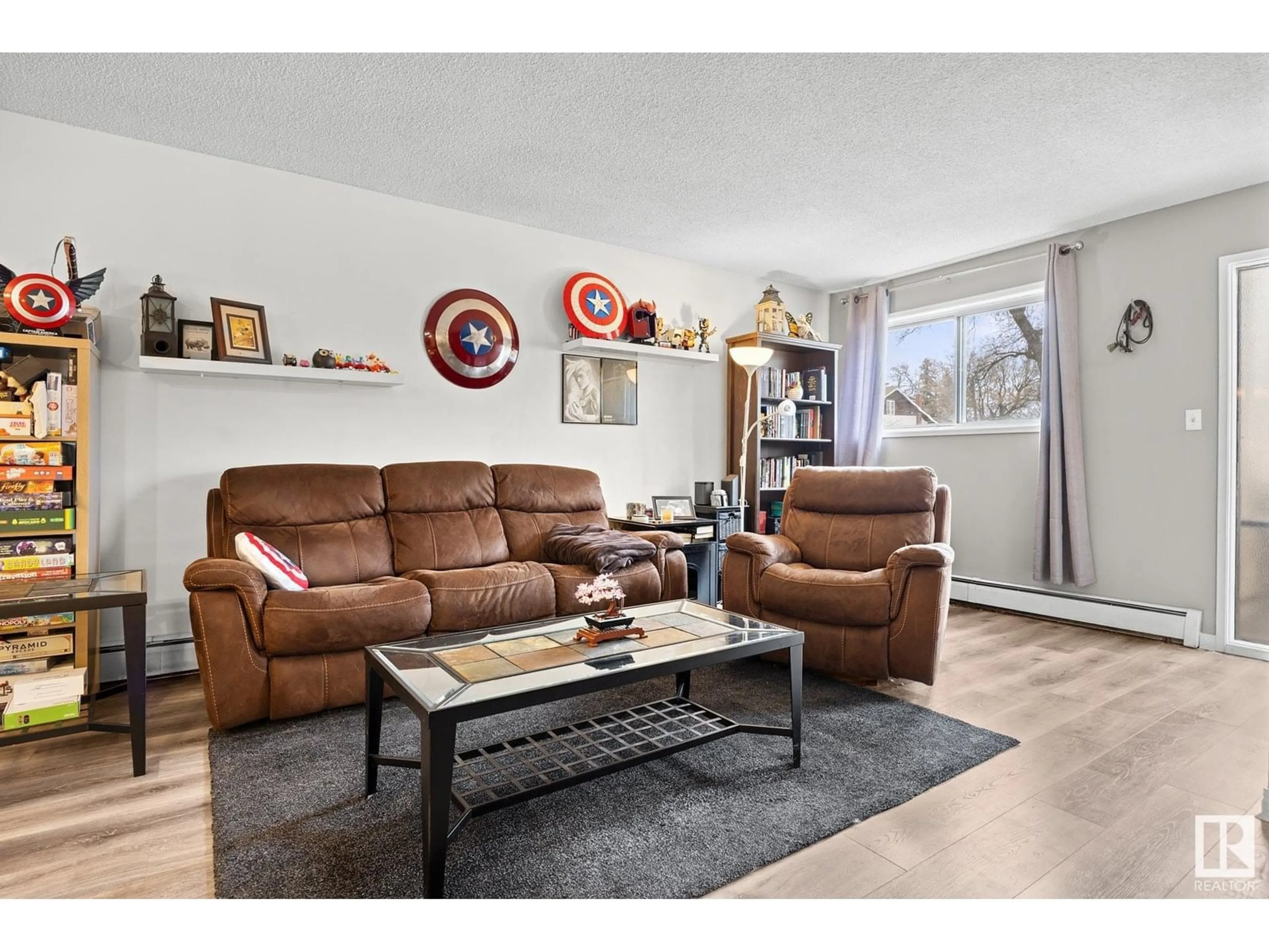 Living room with furniture, wood/laminate floor for 10434 76 AV, Edmonton Alberta T6E1L1