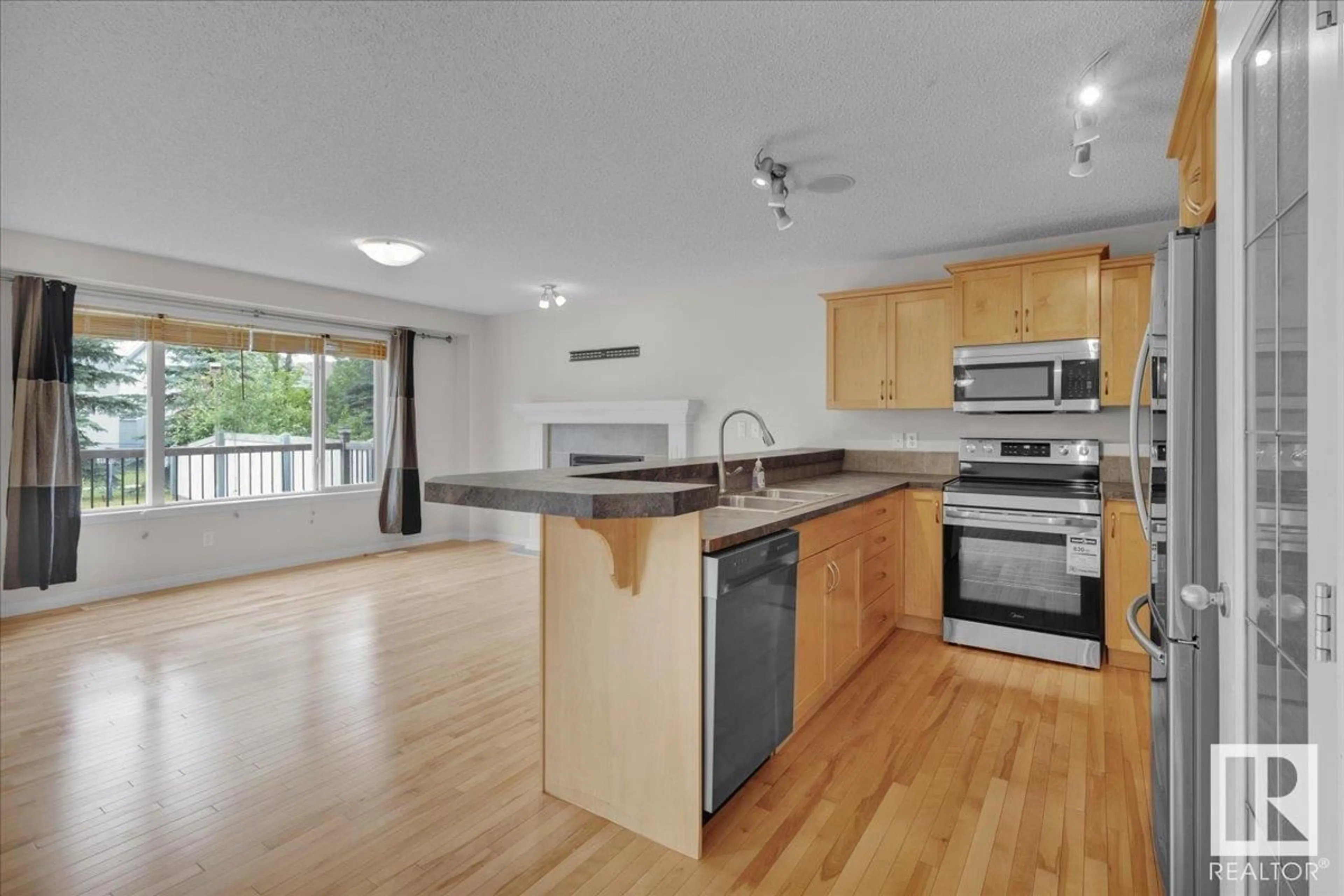 Open concept kitchen, wood/laminate floor for SW - 1510 78 ST, Edmonton Alberta T6X1M1