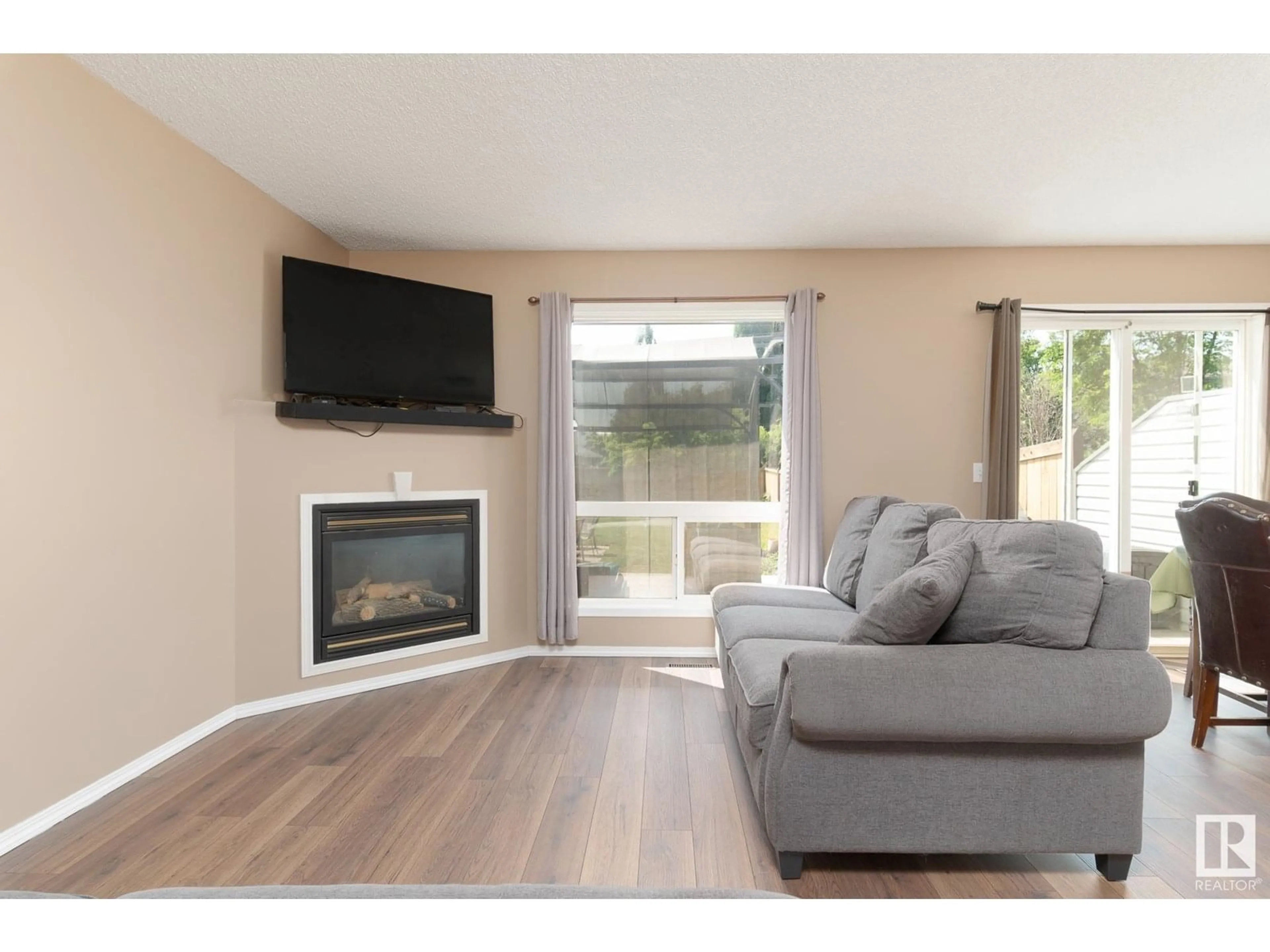 Living room with furniture, wood/laminate floor for 15 NOAH CL, St. Albert Alberta T8N7M2