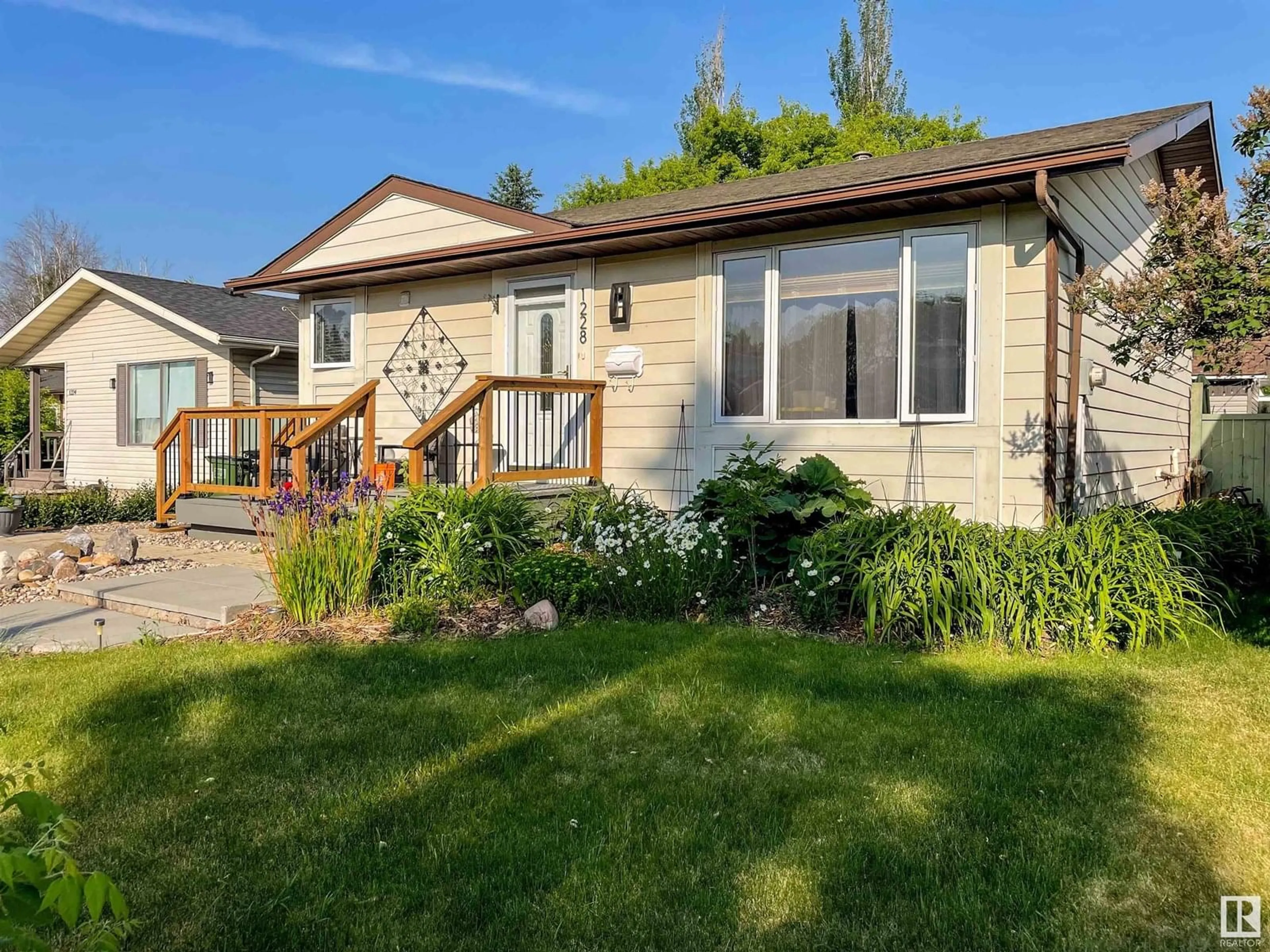 Home with vinyl exterior material, street for NW - 1228 65 ST, Edmonton Alberta T6L2E7
