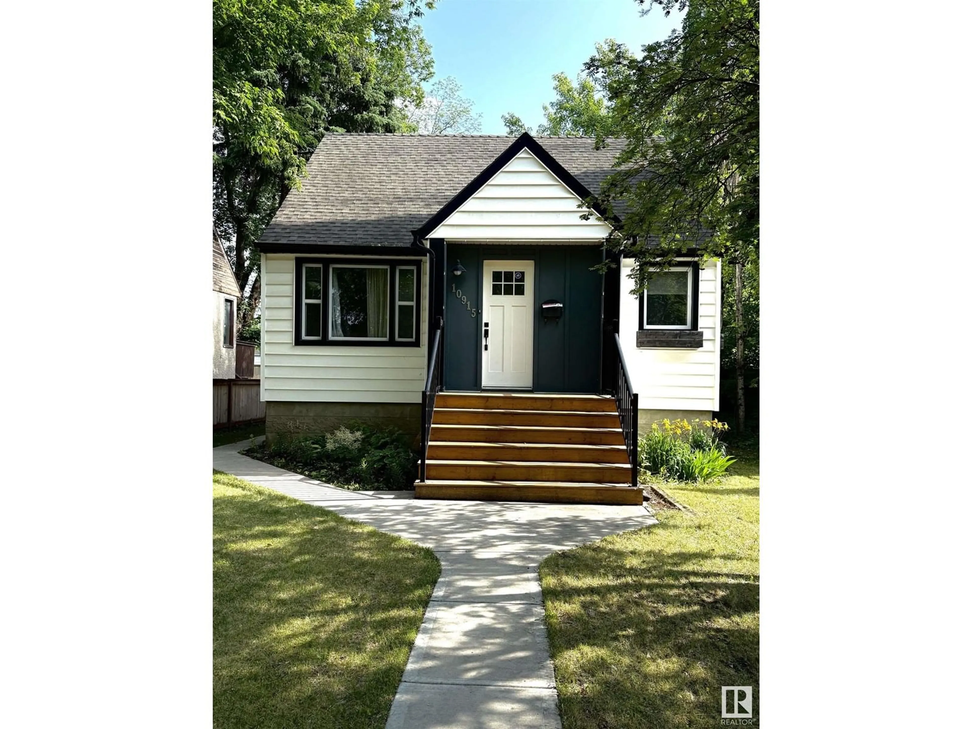 Home with vinyl exterior material, street for 10915 67 AV, Edmonton Alberta T6H2A5