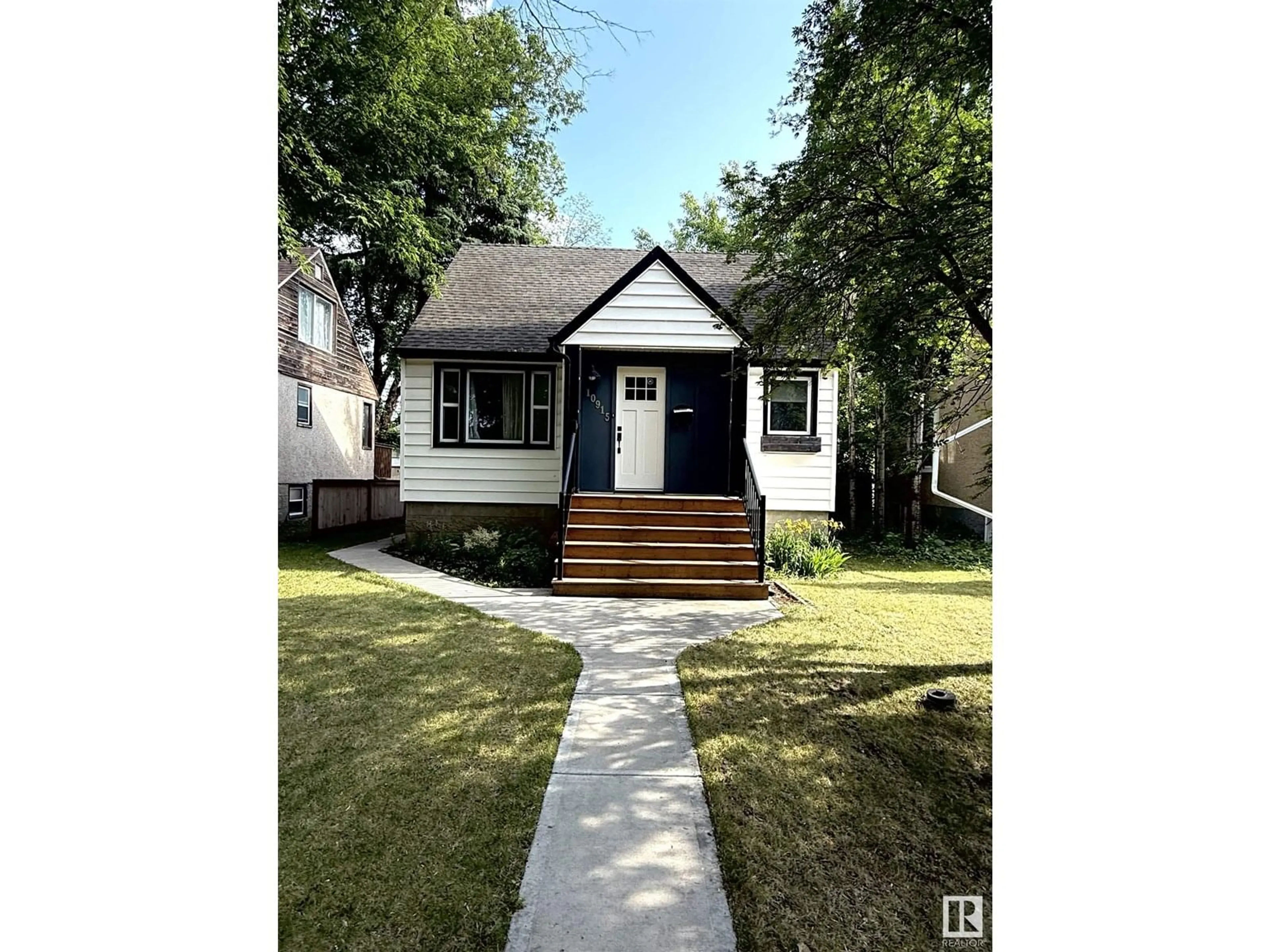 Home with vinyl exterior material, street for 10915 67 AV, Edmonton Alberta T6H2A5