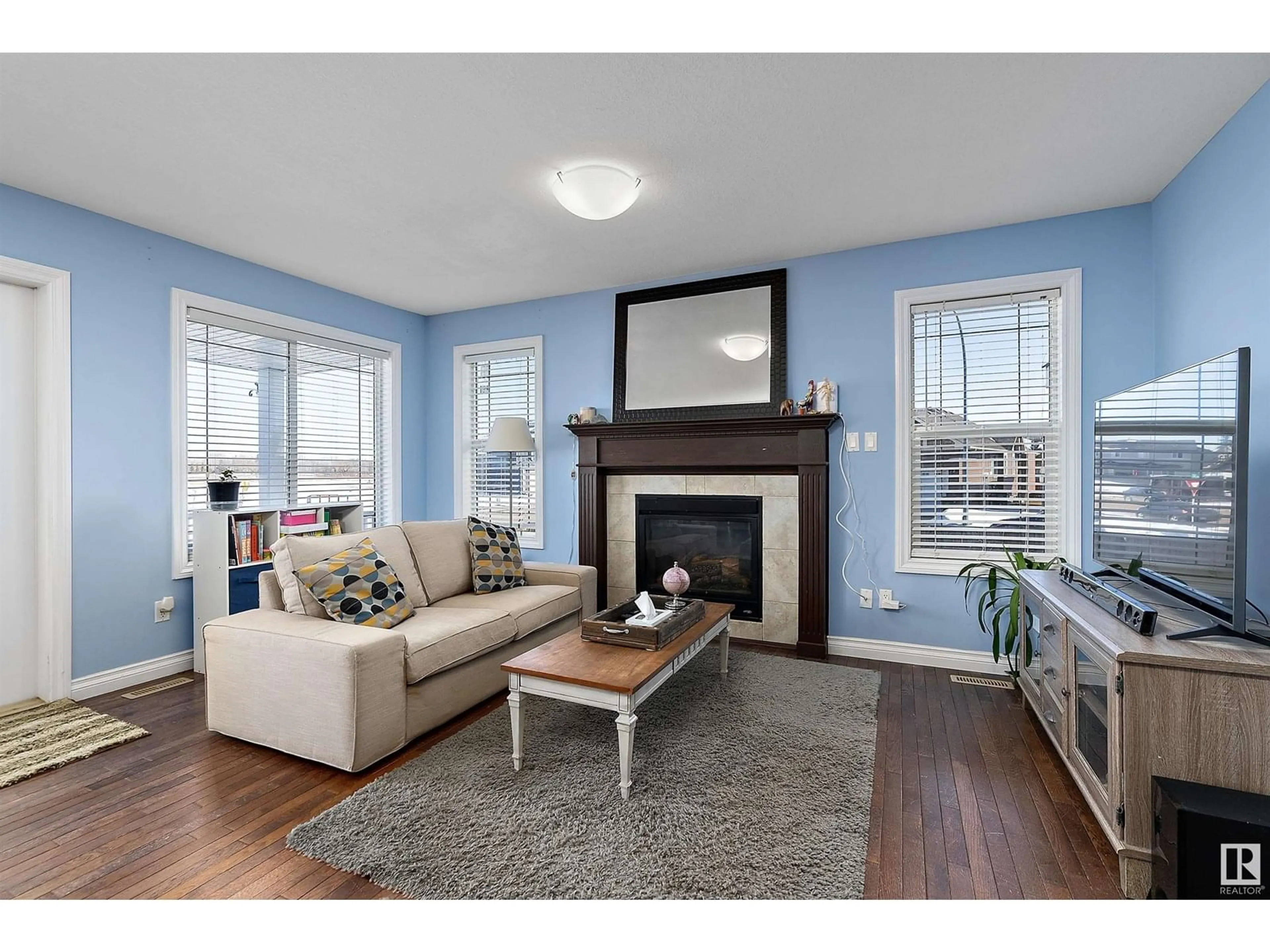 Living room with furniture, wood/laminate floor for 6901 50 AVE, Camrose Alberta T4V5C6