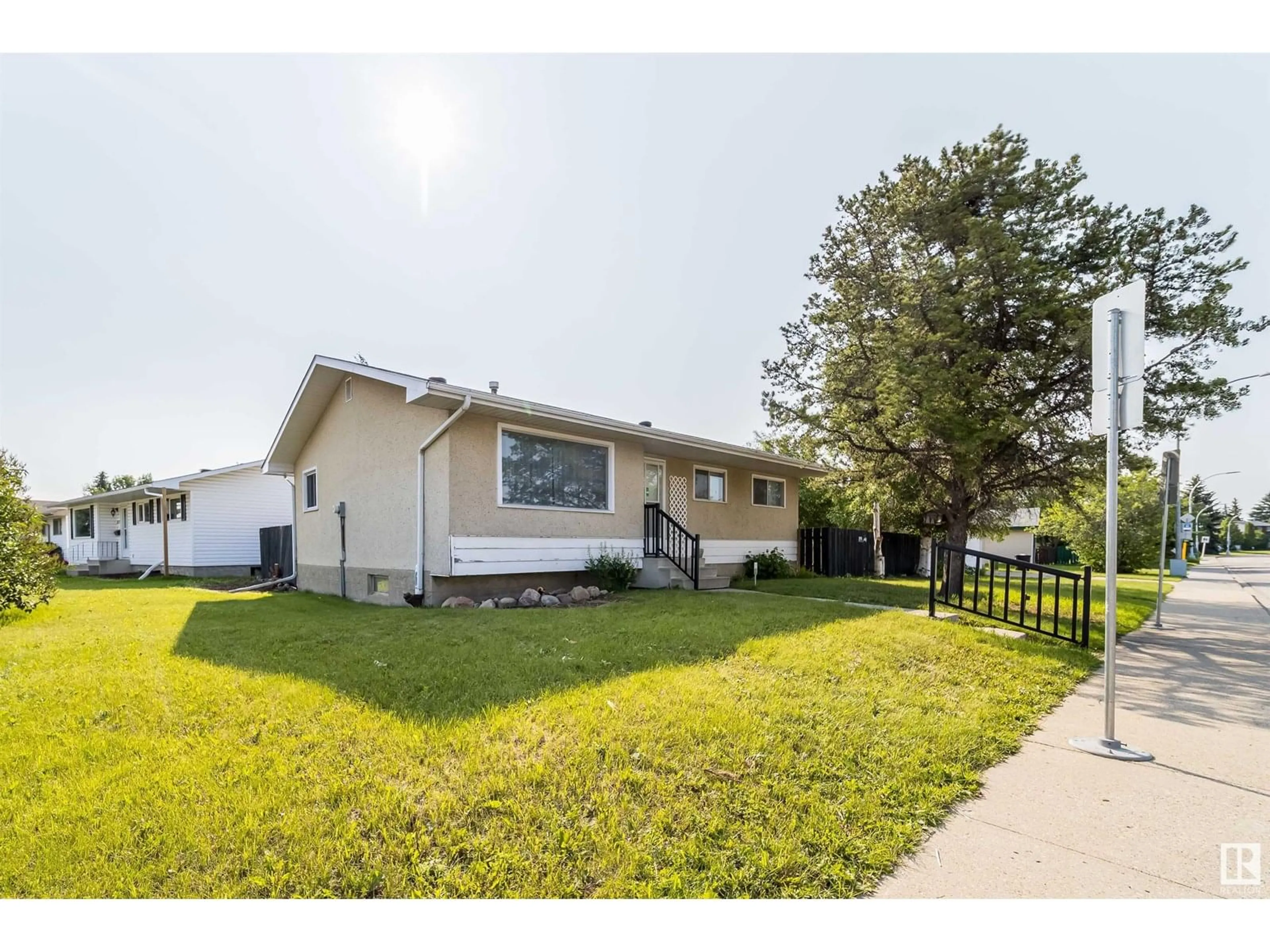 Home with vinyl exterior material, street for NW - 11015 32 ST, Edmonton Alberta T5W1X4