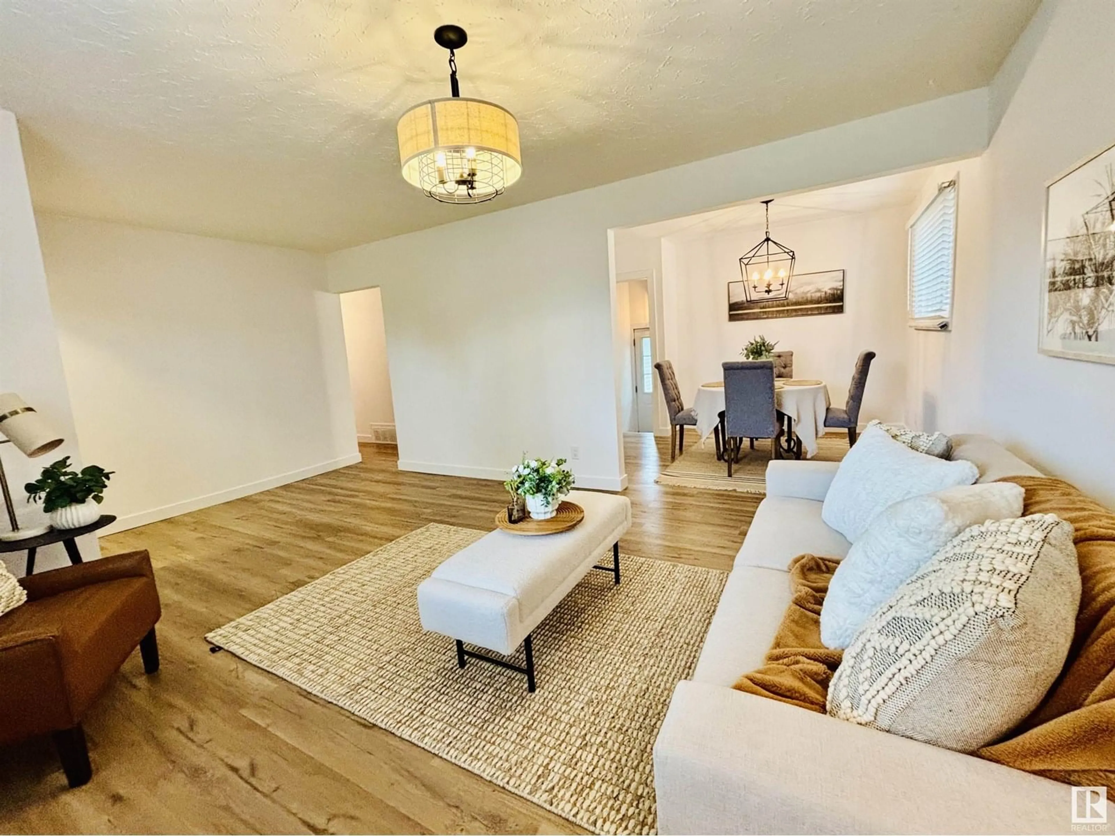 Living room with furniture, wood/laminate floor for NW - 10403 42 ST, Edmonton Alberta T6A1T3