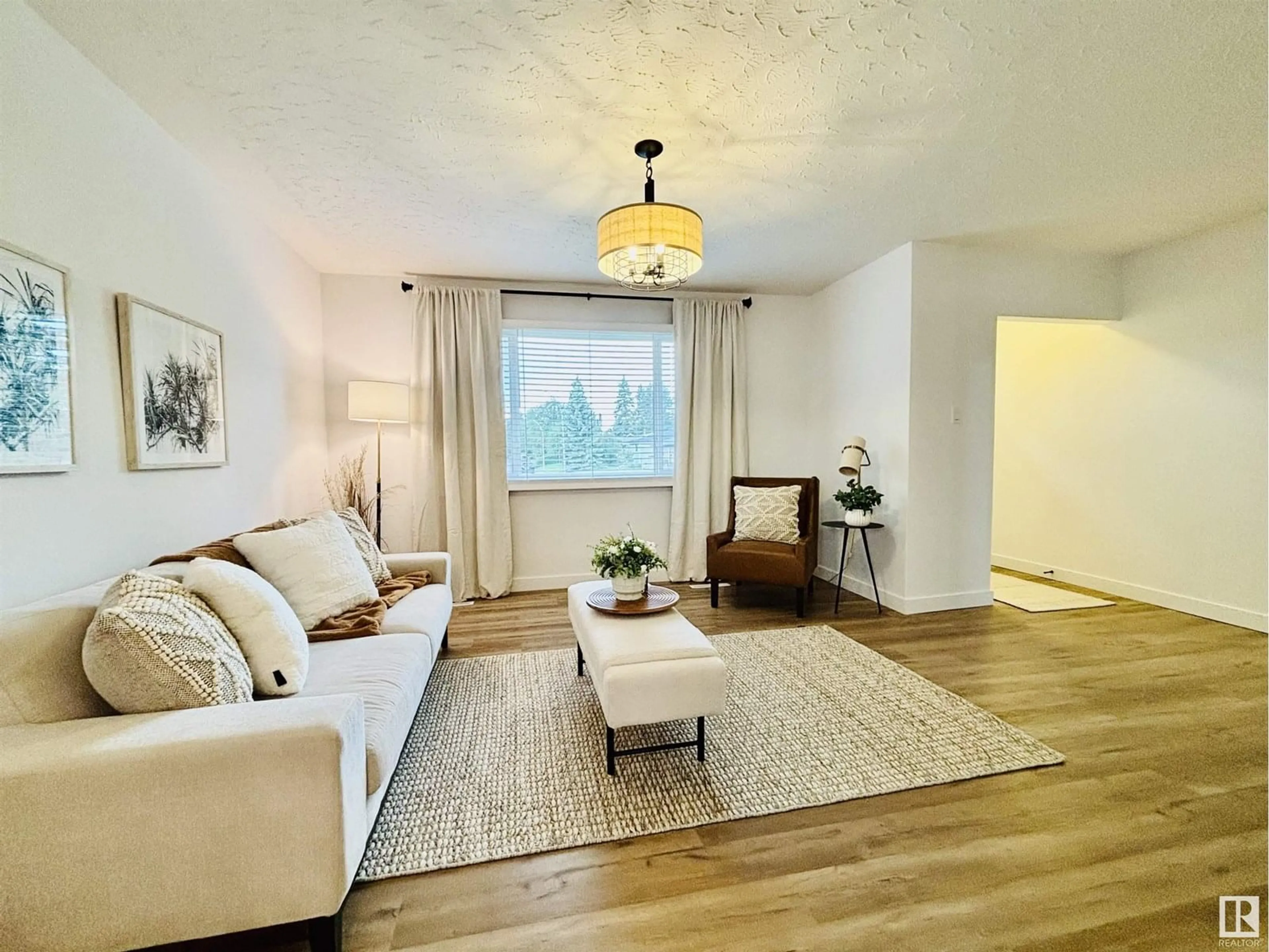 Living room with furniture, wood/laminate floor for NW - 10403 42 ST, Edmonton Alberta T6A1T3