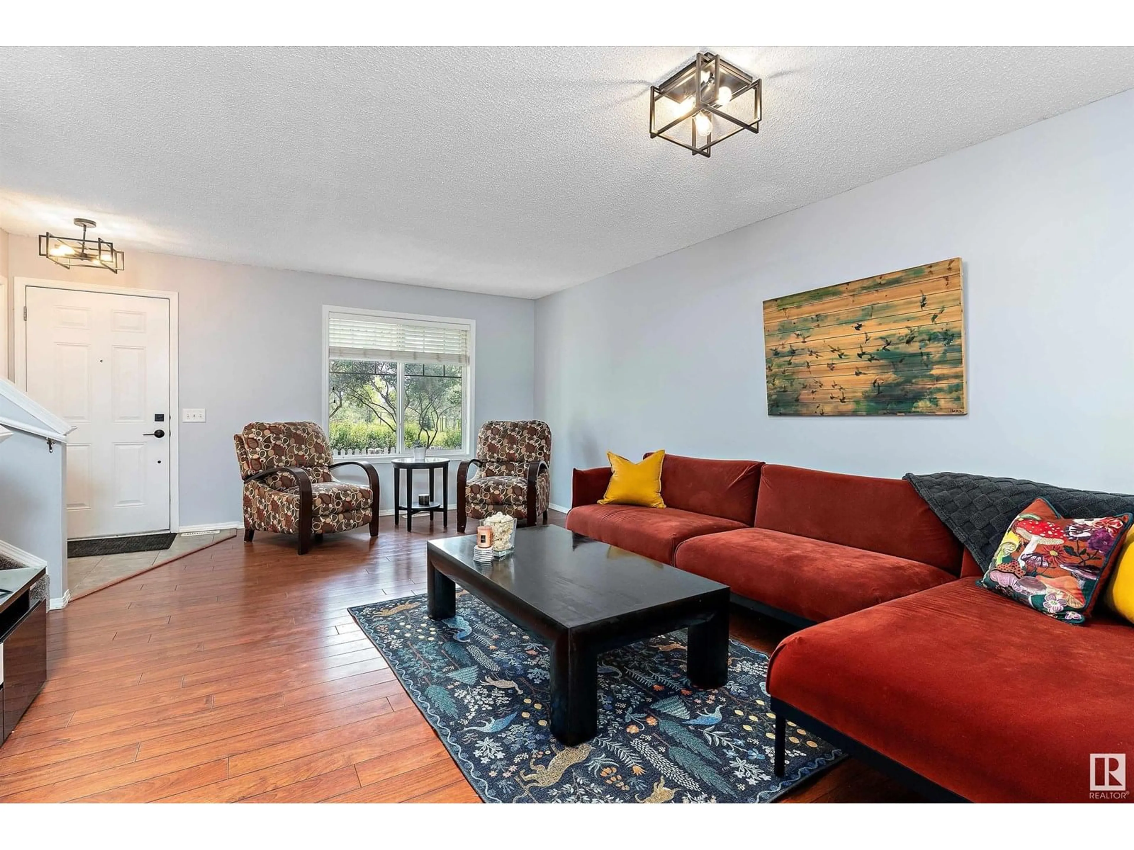 Living room with furniture, wood/laminate floor for 49 3075 TRELLE CR NW, Edmonton Alberta T6R3V5