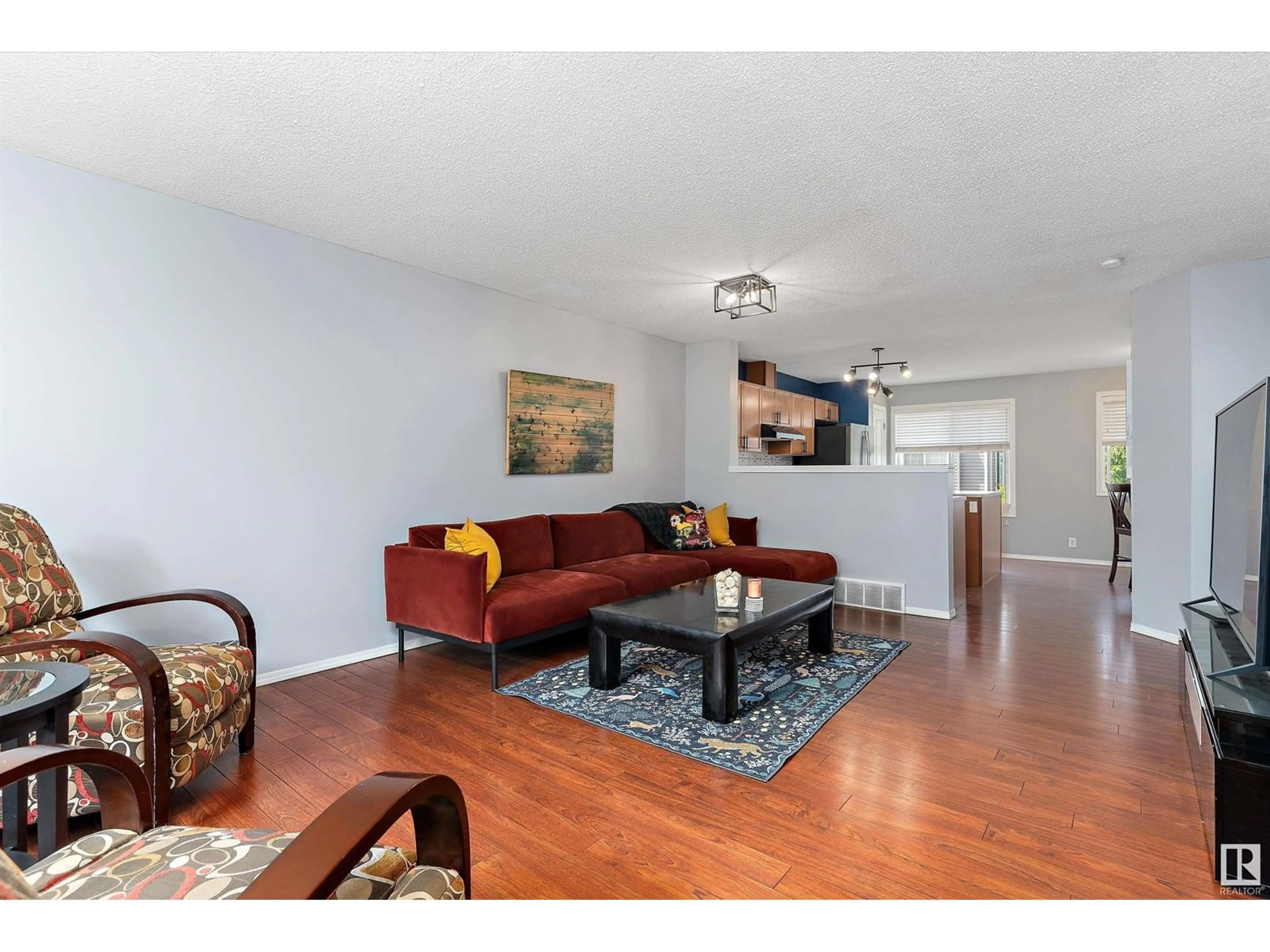 Living room with furniture, wood/laminate floor for 49 3075 TRELLE CR NW, Edmonton Alberta T6R3V5