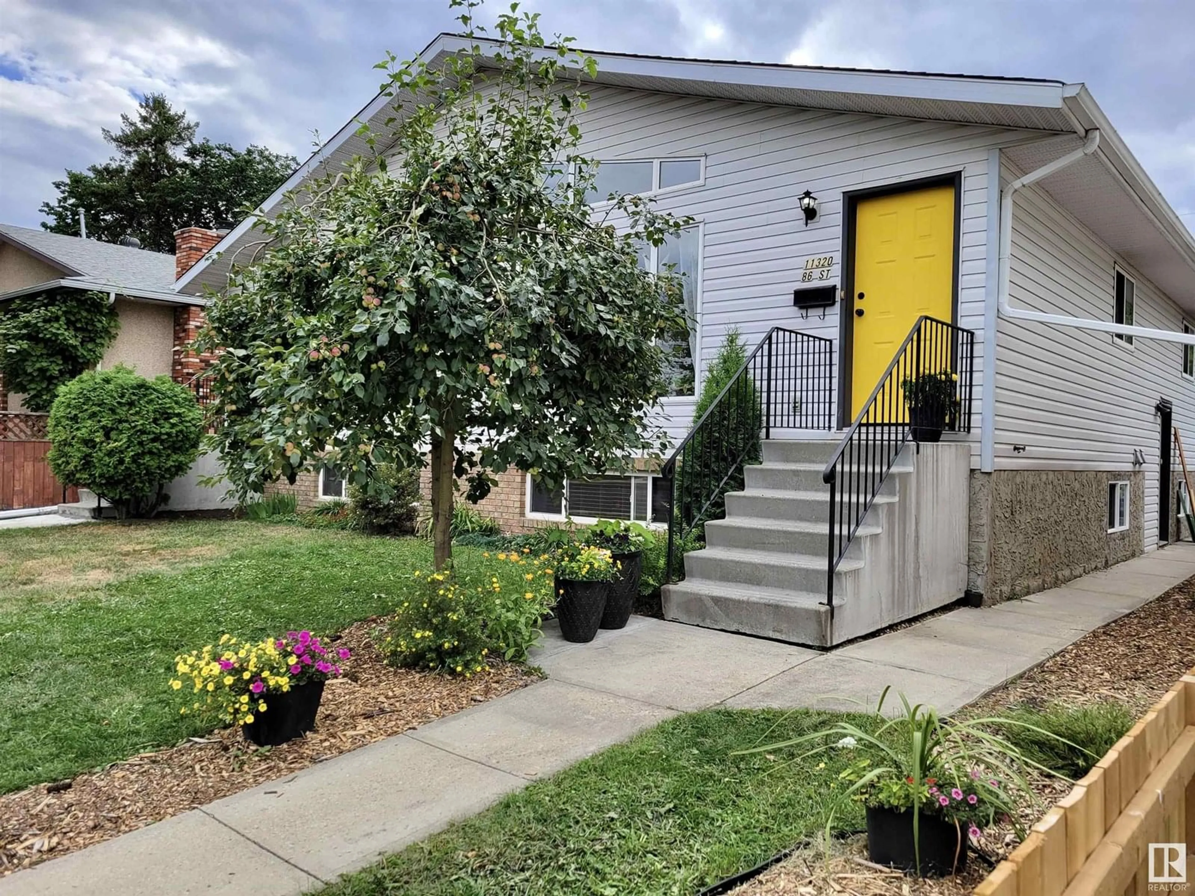Home with vinyl exterior material, street for 11320 86 ST, Edmonton Alberta T5B3J1