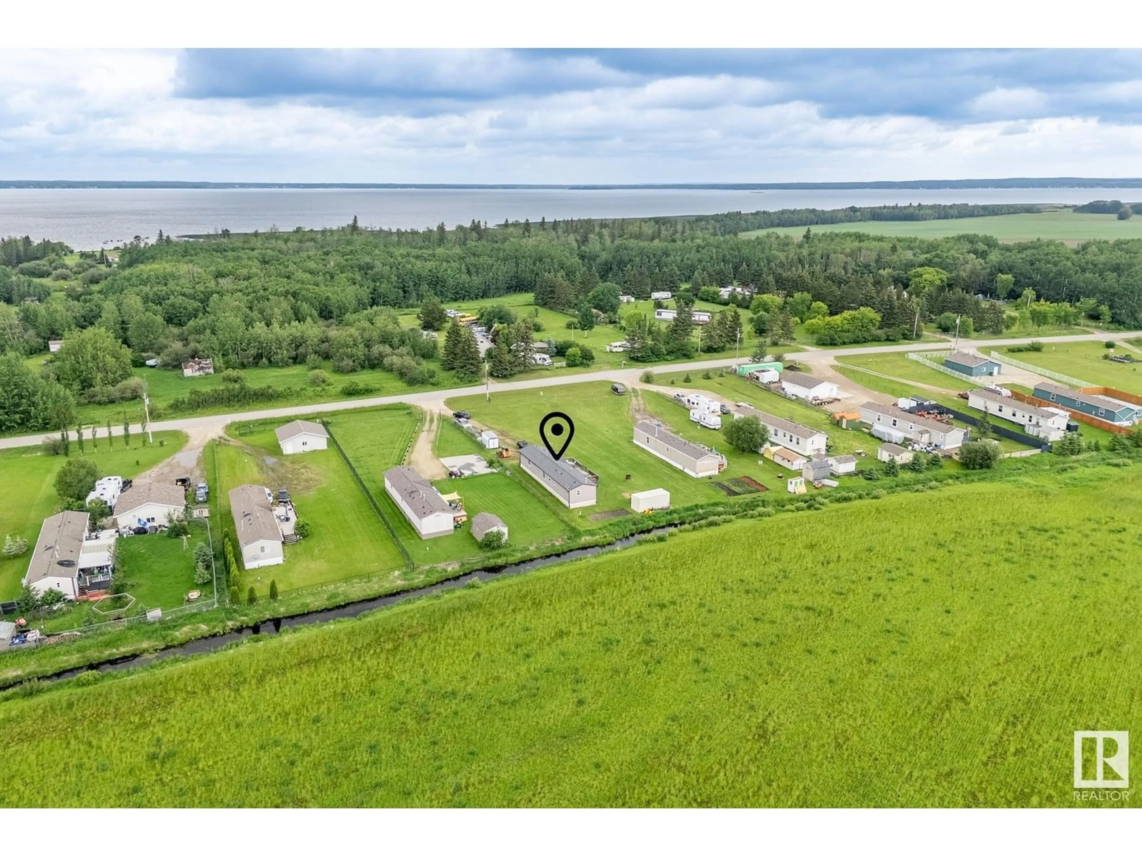 A pic from outside/outdoor area/front of a property/back of a property/a pic from drone, water/lake/river/ocean view for 149 3510 STE. ANNE TR, Rural Lac Ste. Anne County Alberta T0E0A0