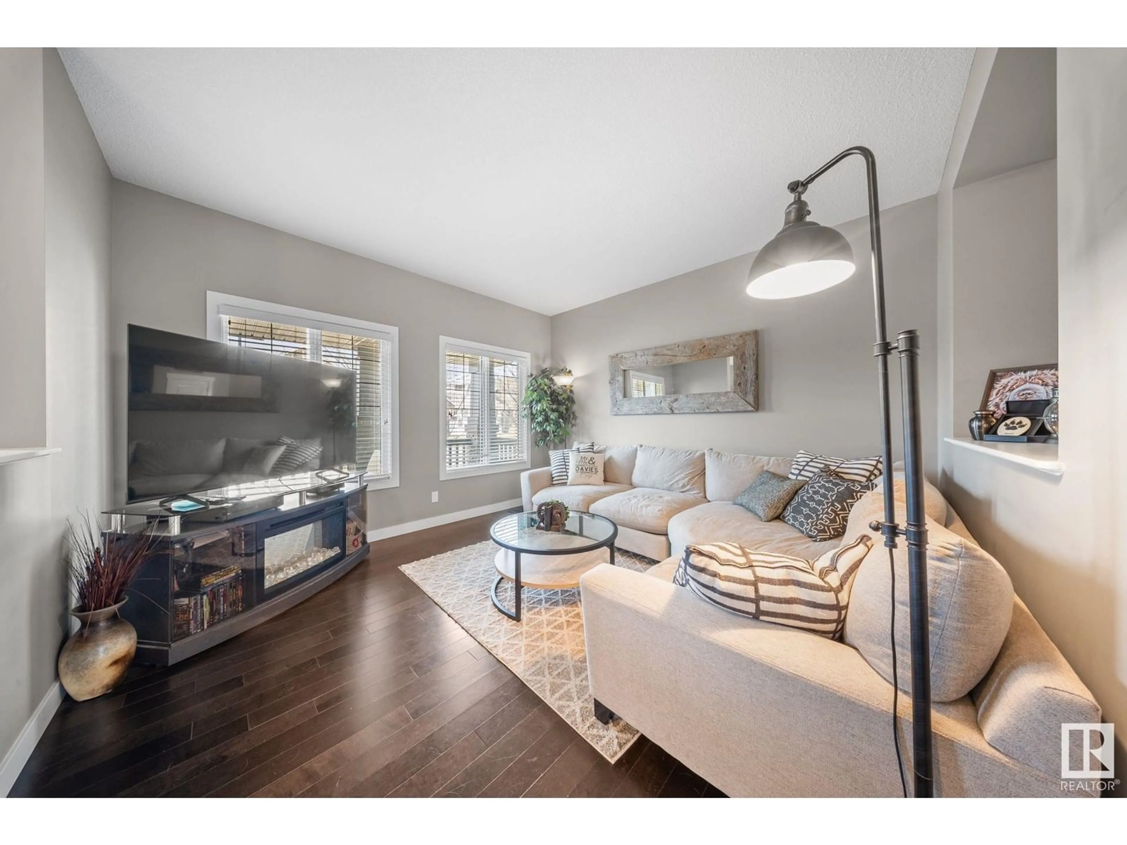 Living room with furniture, wood/laminate floor for 8107 224 ST, Edmonton Alberta T5T7A4