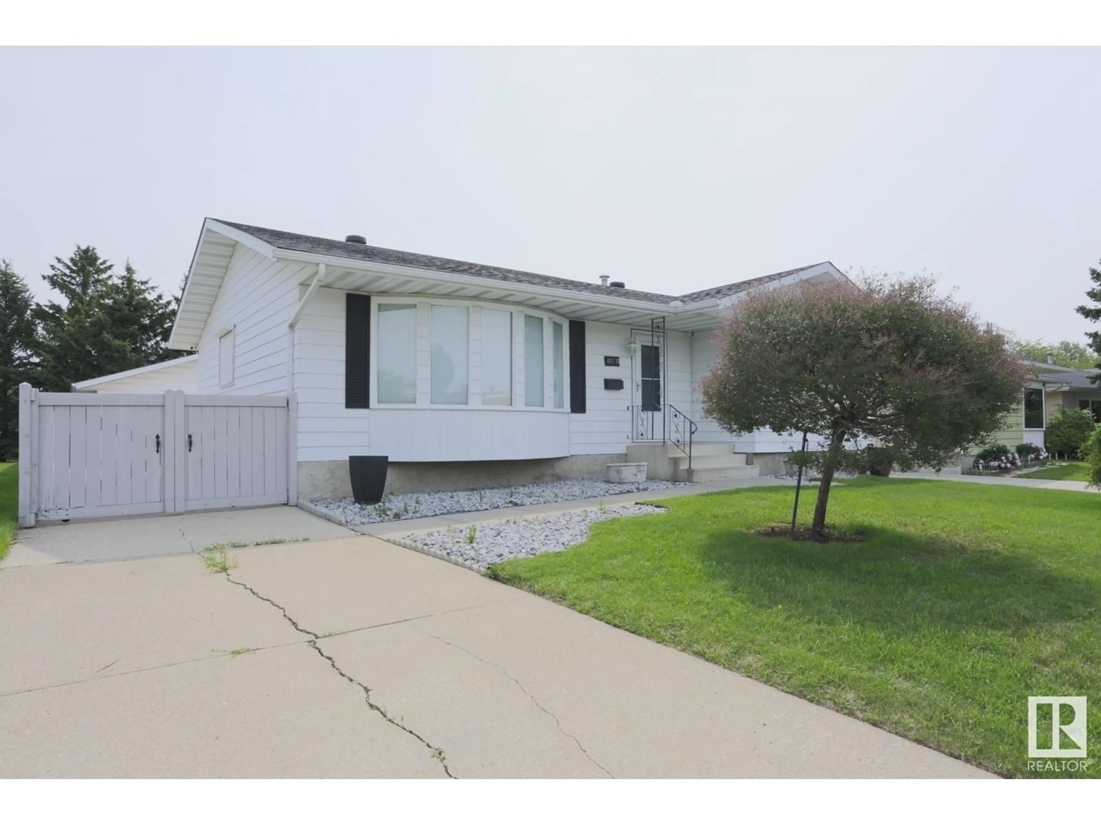 Home with vinyl exterior material, street for 4011 74 ST, Edmonton Alberta T6K0W7
